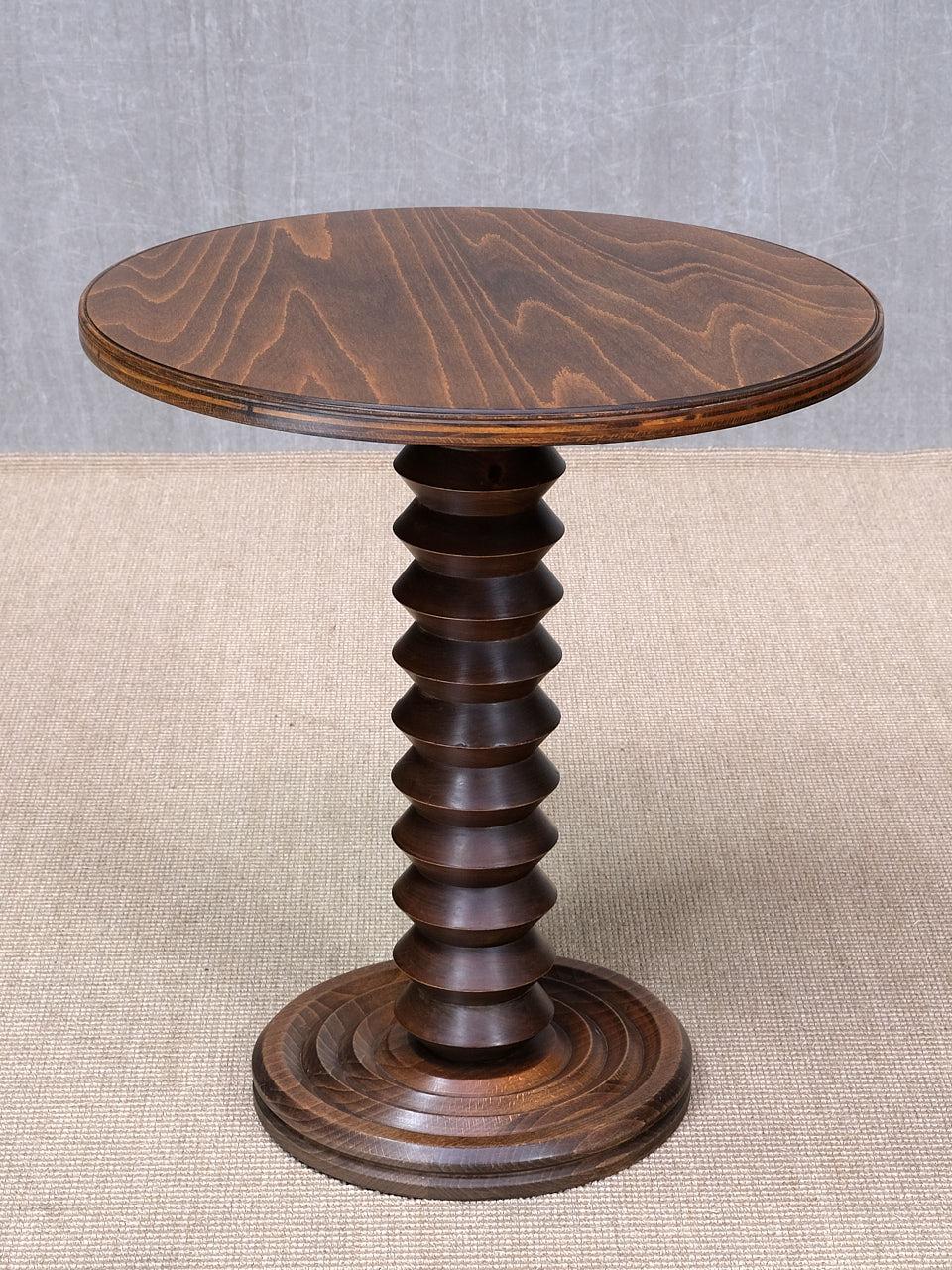 This rare side table was designed by Charles Dudouyt and produced in France in the late 1940s. The different carved shapes of the wood illustrate the craftsmanship and originality of Dudouyt’s production. This striking design is well sized for use