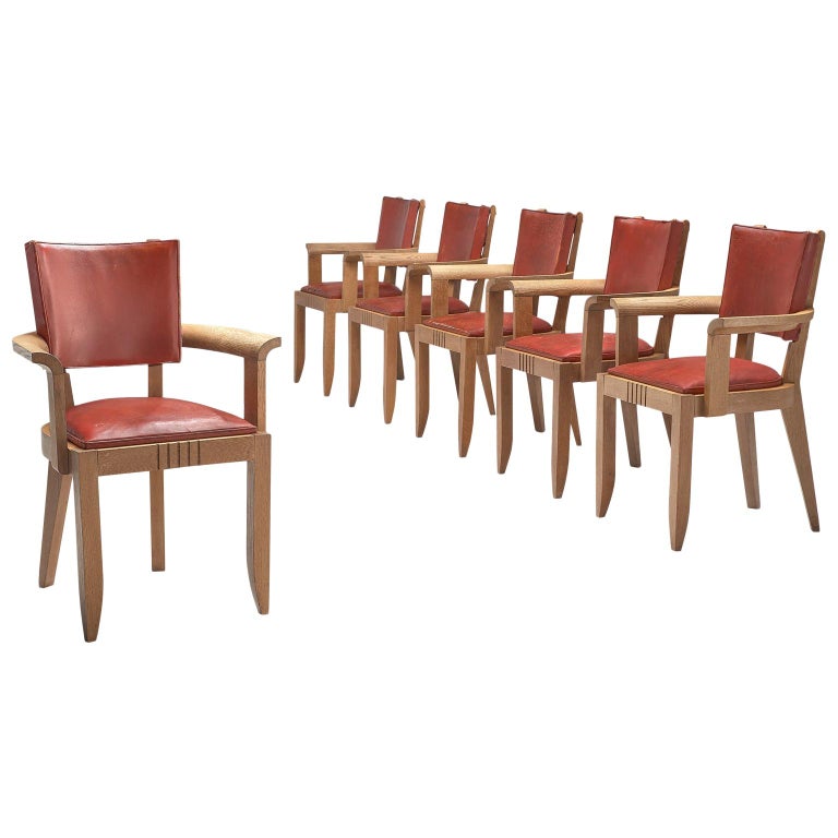 Charles Dudouyt red leather dining chairs, 1930s, offered by MORENTZ