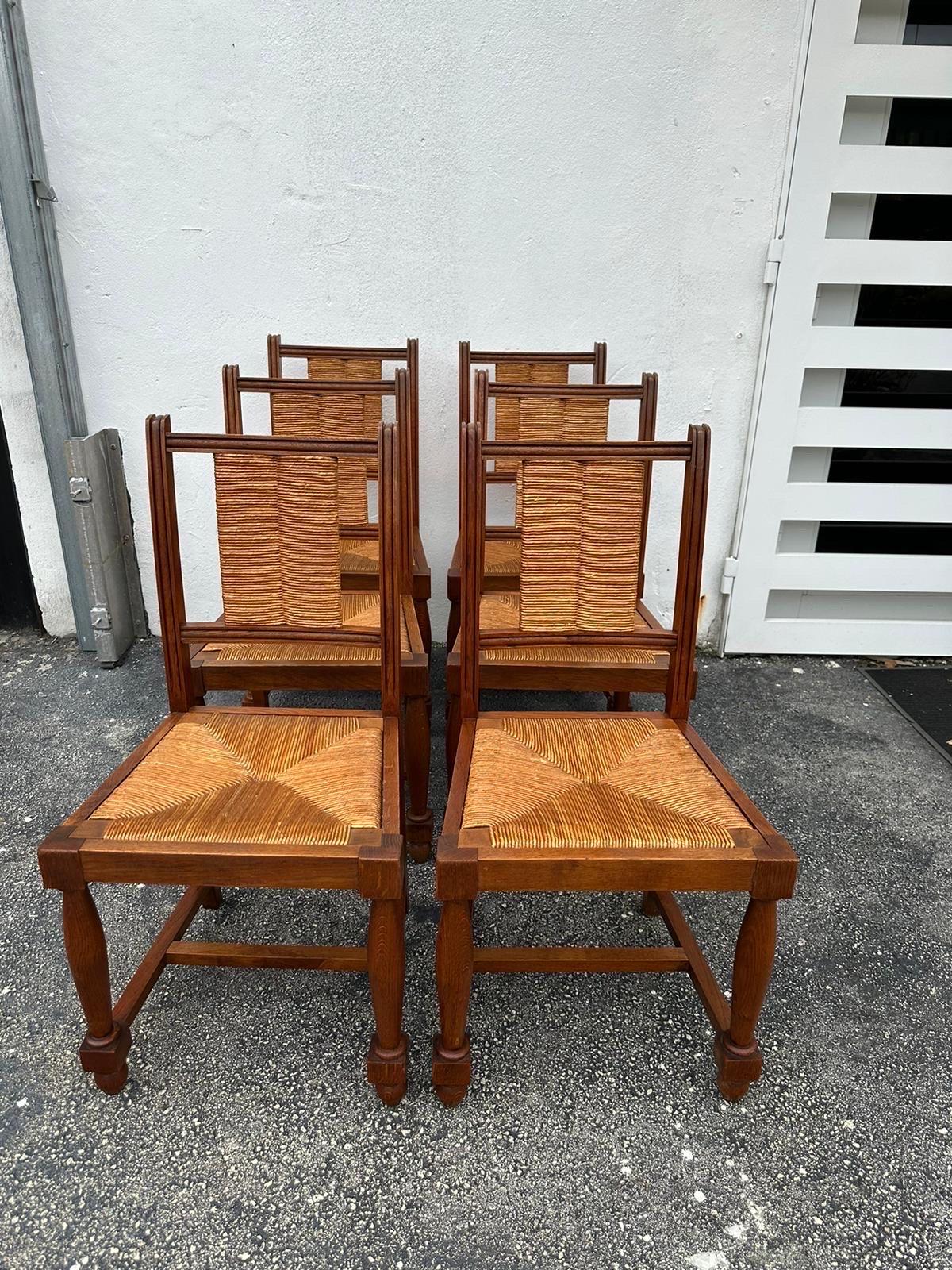 Vintage Walnut and rush seat dining chairs by Charles Dudouyt, France 1940s.  Dudouyt crafted wooden furniture in strong Art Deco/ brutalist forms, using playful geometries and construction methods more in keeping with the robust Arts and Crafts