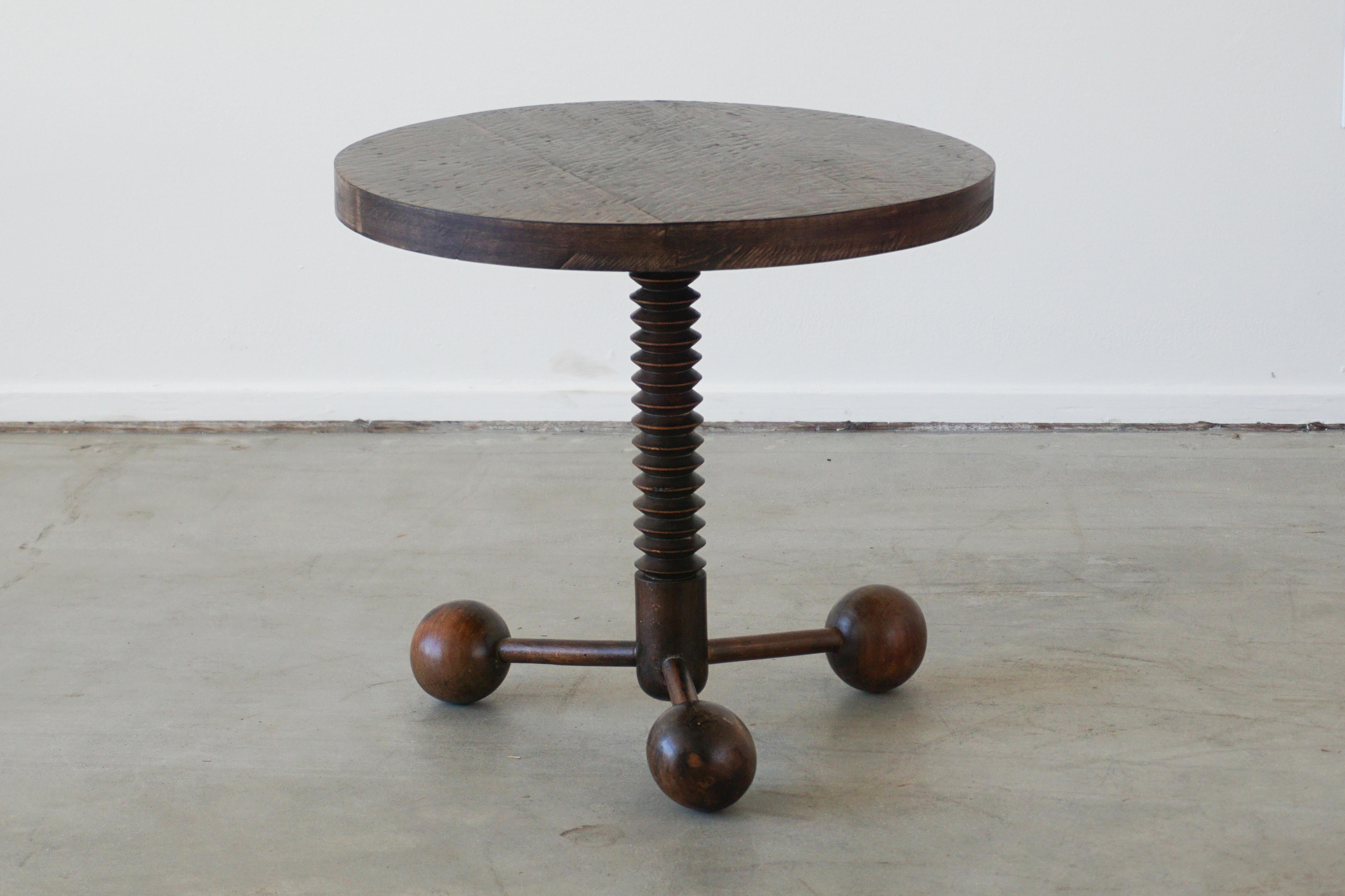 Charles Dudouyt side table with three wood balled feet and carved corkscrew base, and carved top. 
Wonderful patina throughout.