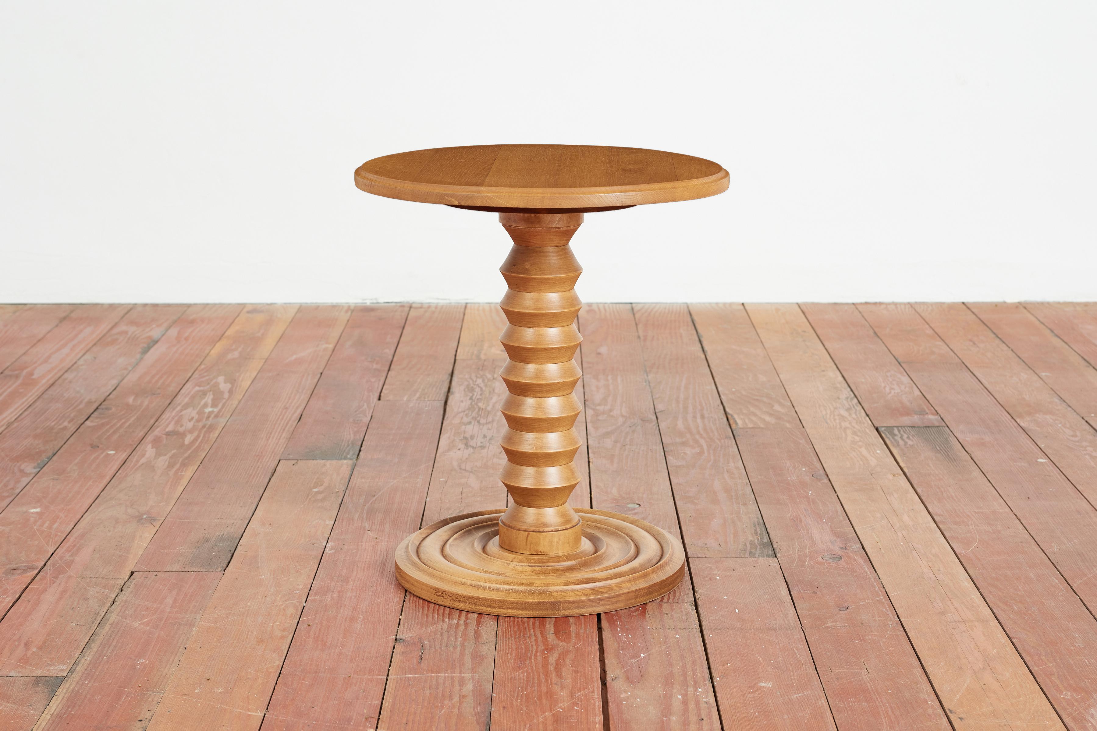 Chic Charles Dudouyt side table with signature carved corkscrew base in raw oak finish. 

France, Circa 1940s.