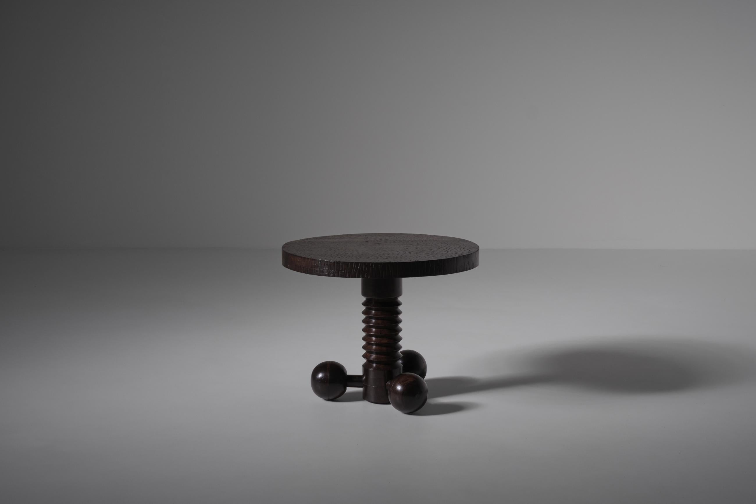 Art-deco side table by Charles Dudouyt, France 1940s. A dark stained mahogany round table top rests on a beautiful detailed base constructed out of a corkscrew shaped centre collum, the base of the table is made out three wooden balls; All hand