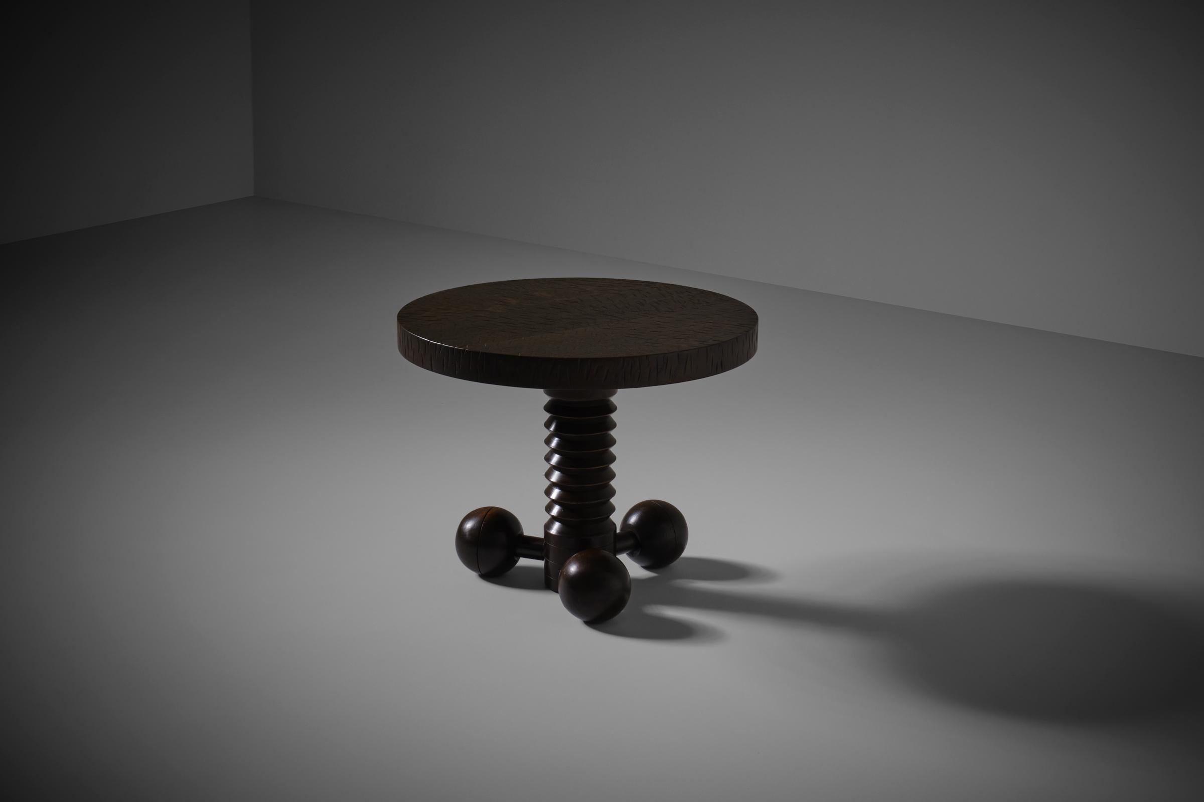 Rare Art-deco side table by Charles Dudouyt, France 1940s. A dark stained wooden table top rests on a beautiful detailed base constructed out of a corkscrew shaped centre collum, the base of the table is made out three wooden balls. All tables where