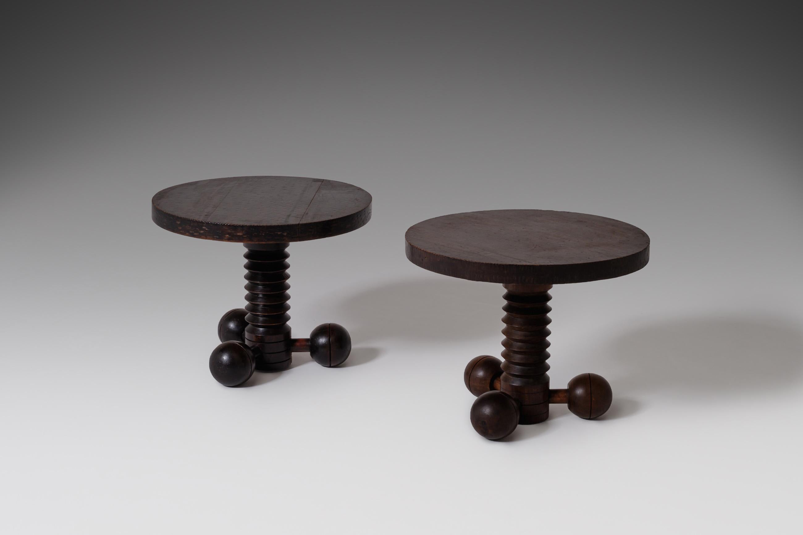 Rare set two Art Deco side tables by Charles Dudouyt, France, 1940s. A dark stained mahogany round tabletop rests on a beautiful detailed base constructed out of a corkscrew shaped centre collum, the base of the table is made out three wooden balls;