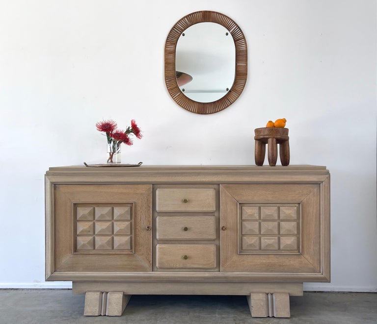 Charles Dudouyt designed sideboard circa 1940's.
Refinished in bleached oak with signature carved door fronts and ample interior storage 
Original keys.