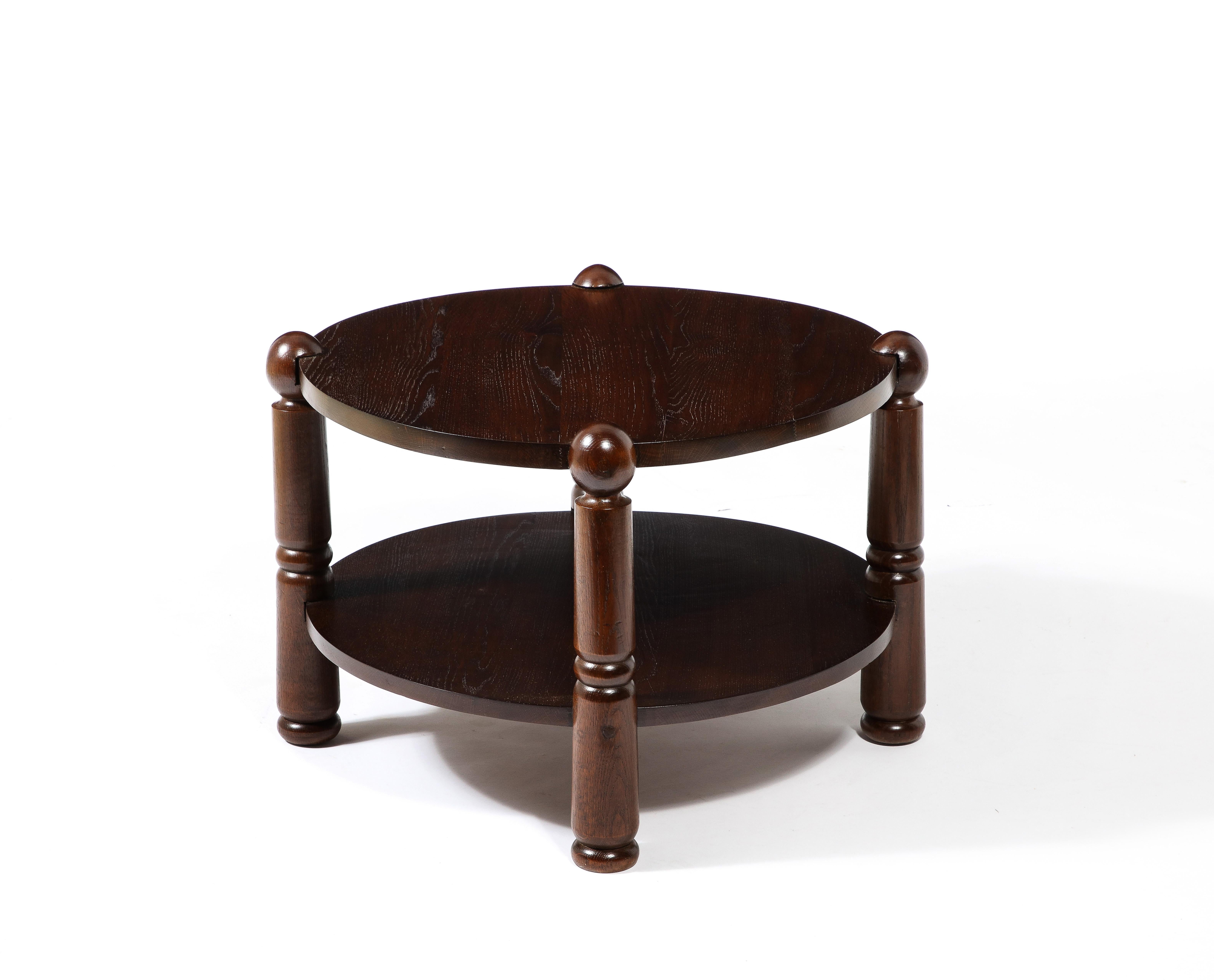 Solid oak side table with ringed pin legs; the levels are encased in the legs. Reminiscent of the 