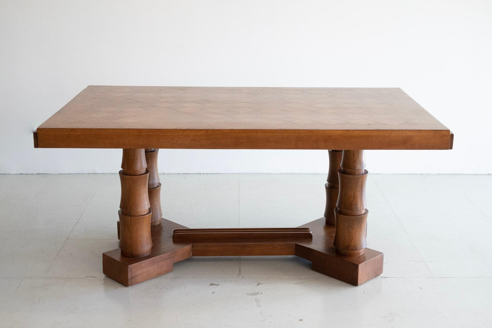 Beautiful oak table by Charles Dudouyt with carved pedestal legs.
Gorgeous butcher block patchwork oak top. 
Newly refinished with wonderful patina.