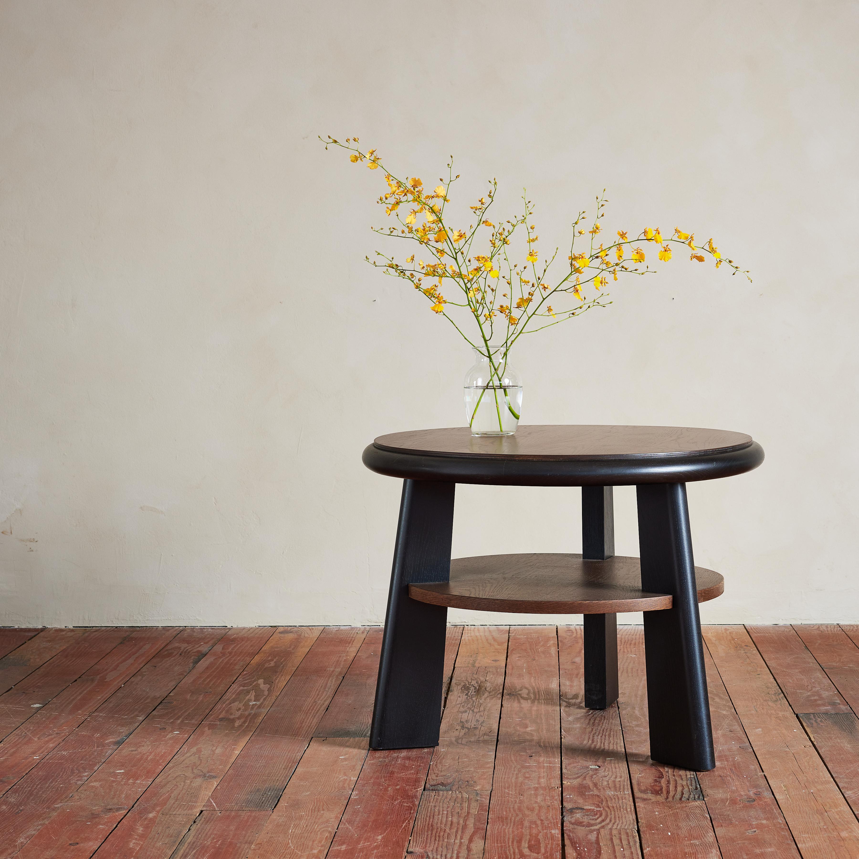 Incredible Charles Dudouyt two tiered table with thick wood top and three angular legs.  Top and legs have original dark finish and lighter wood shelf. 

Fantastic piece. 

France 1940s.