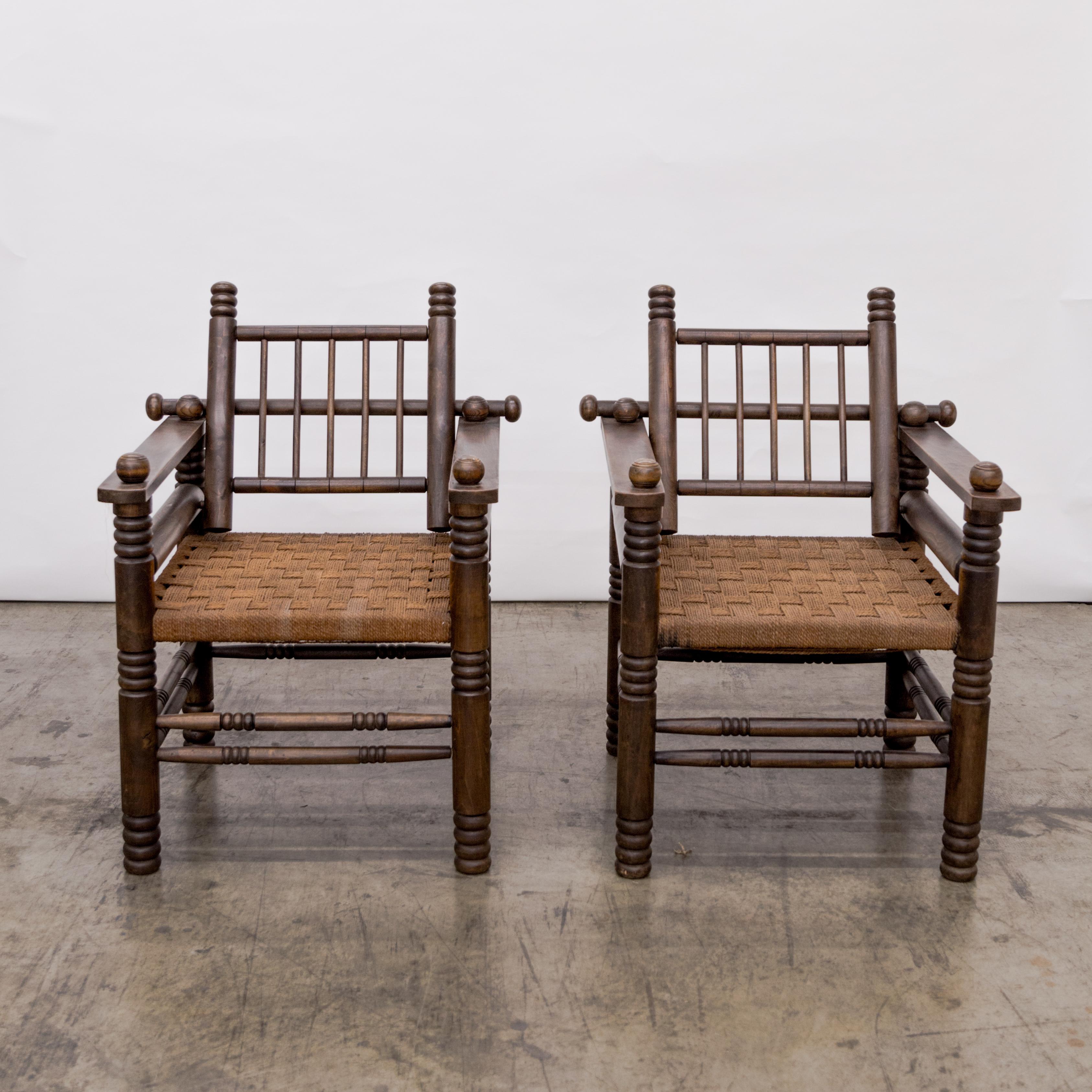 Pair of woven rush seat armchairs with turned walnut legs and rails by Charles Dudouyt.