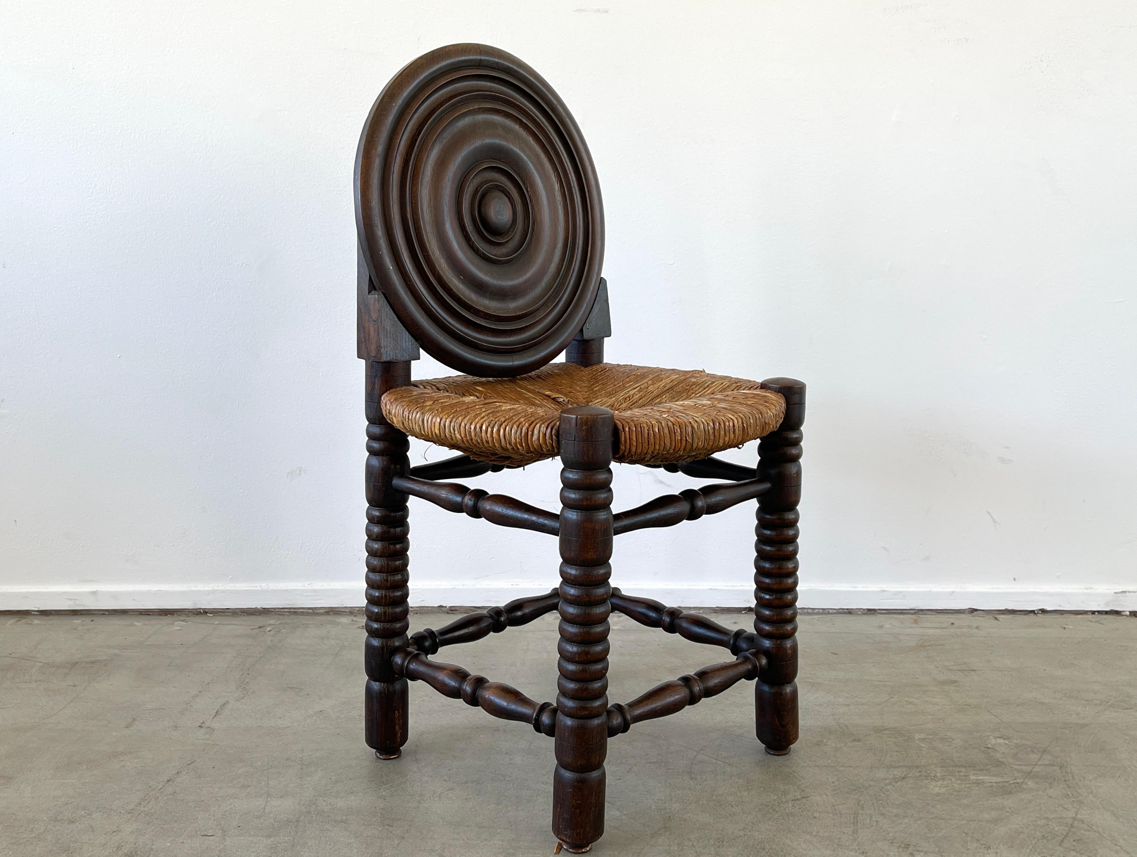 Single side chair attributed to Charles Dudouyt with signature corkscrew legs, concentric carved circled back and rushed seat.