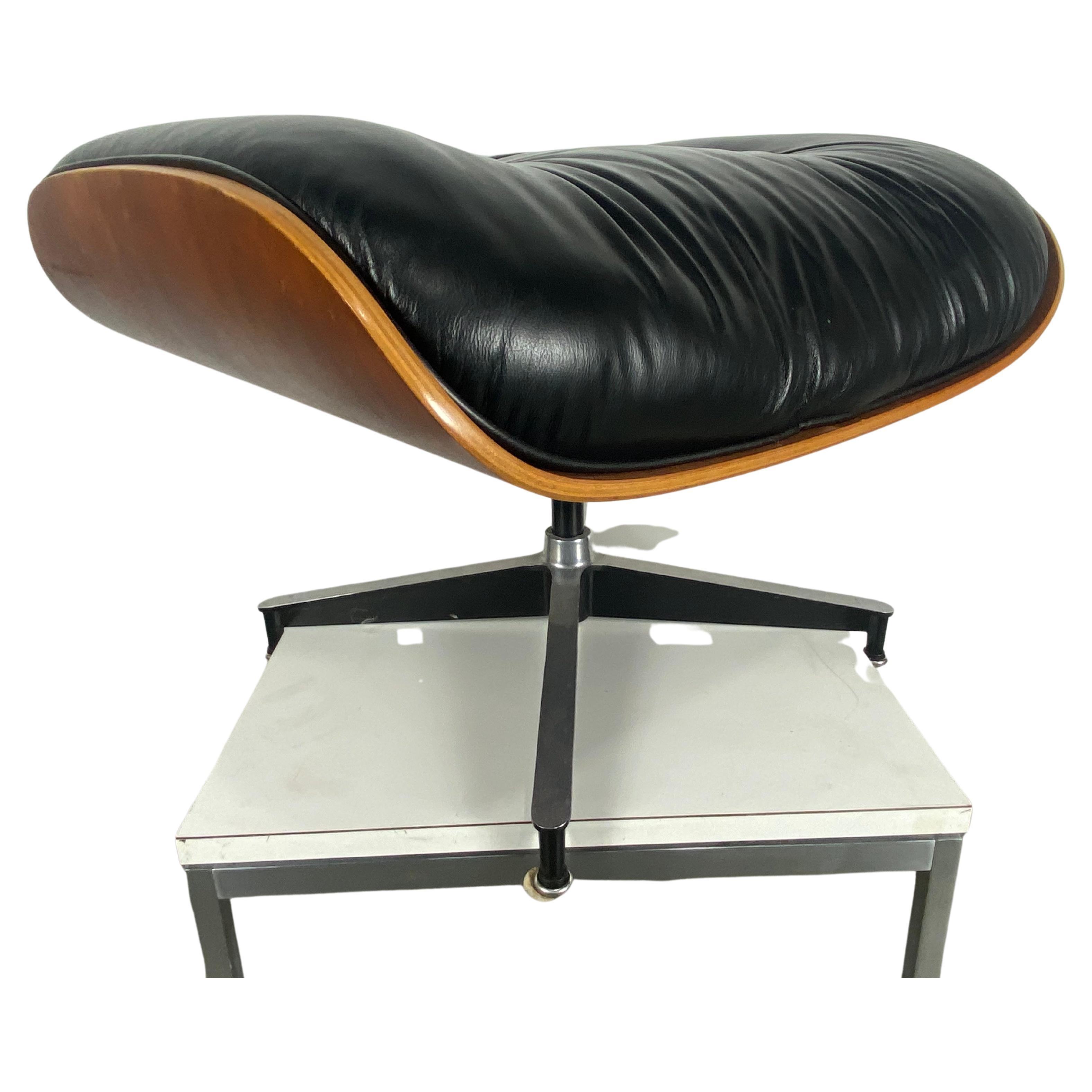 Charles & Ray Eames black leather and wood ottoman for lounge chair, Herman Miller, circa 1970s
Manufacturer label underneath. Black base with white glides. Cushion filled with feathers.
Original vintage very nice condition.