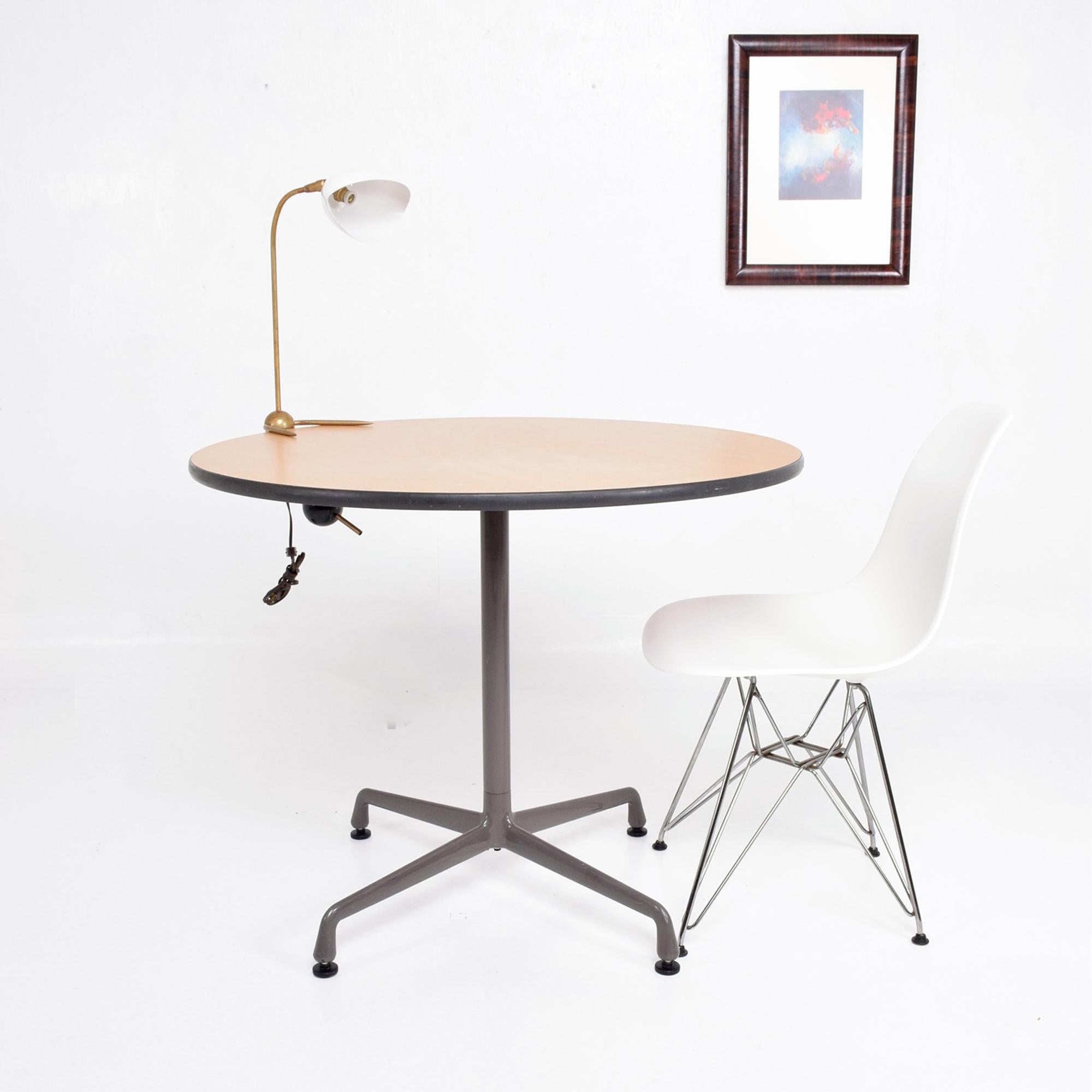 Table
Herman Miller Aluminum Group Small Round Office Table 
Manufacturer Herman Miller Charles & Ray Eames designer.
With label.
Made in Aluminum and Formica. circa 1960s
Four Star Base with Round Top
29.25 tall x 35.75 in diameter.
Wear consistent