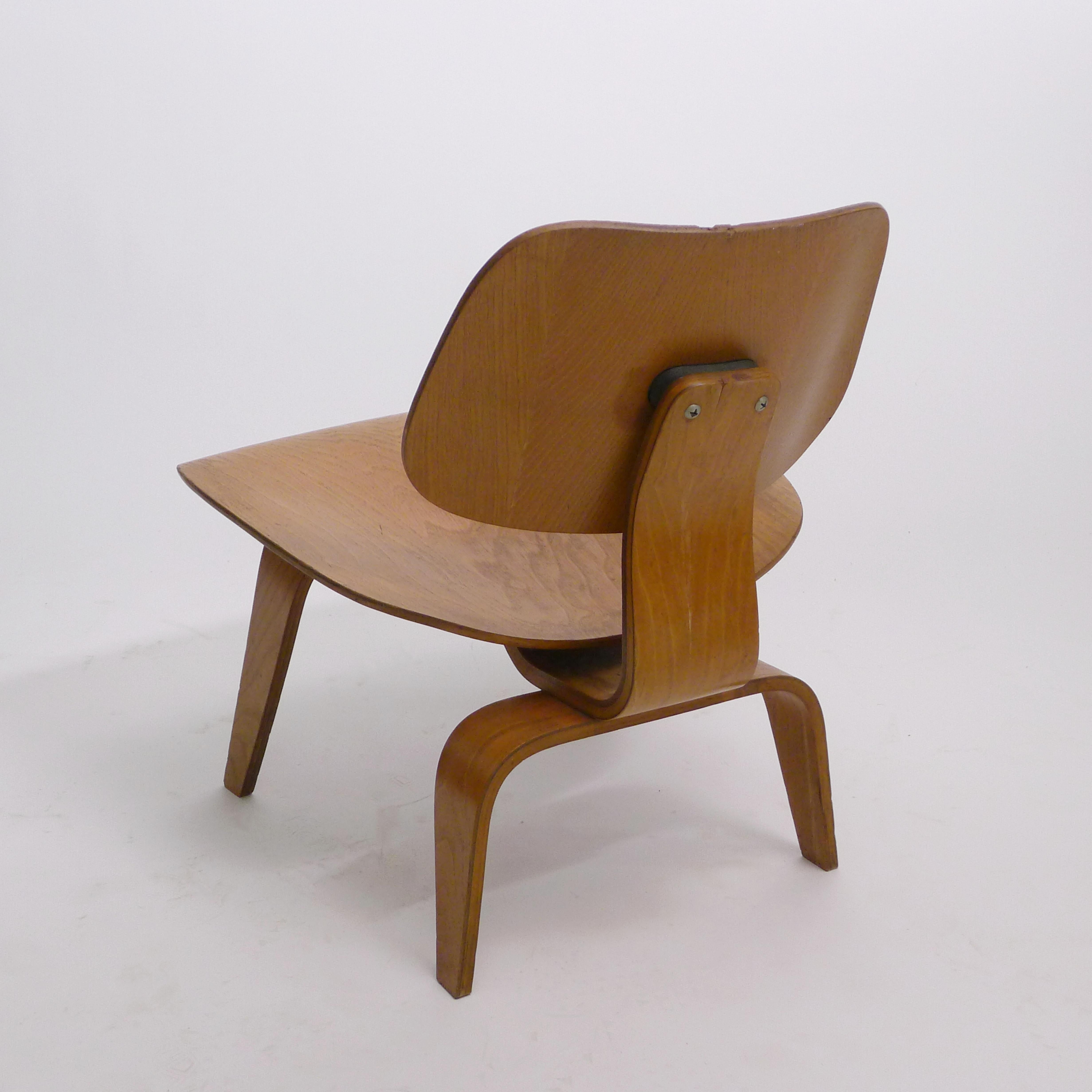 Charles and Ray Eames original LCW (Lounge Chair Wood) in ash plywood. 

Designed circa 1946 this example has the early 5-2-5 screw configuration employed by the first manufacturer, Evans Plywood and the label dates it as a 4th edition produced in