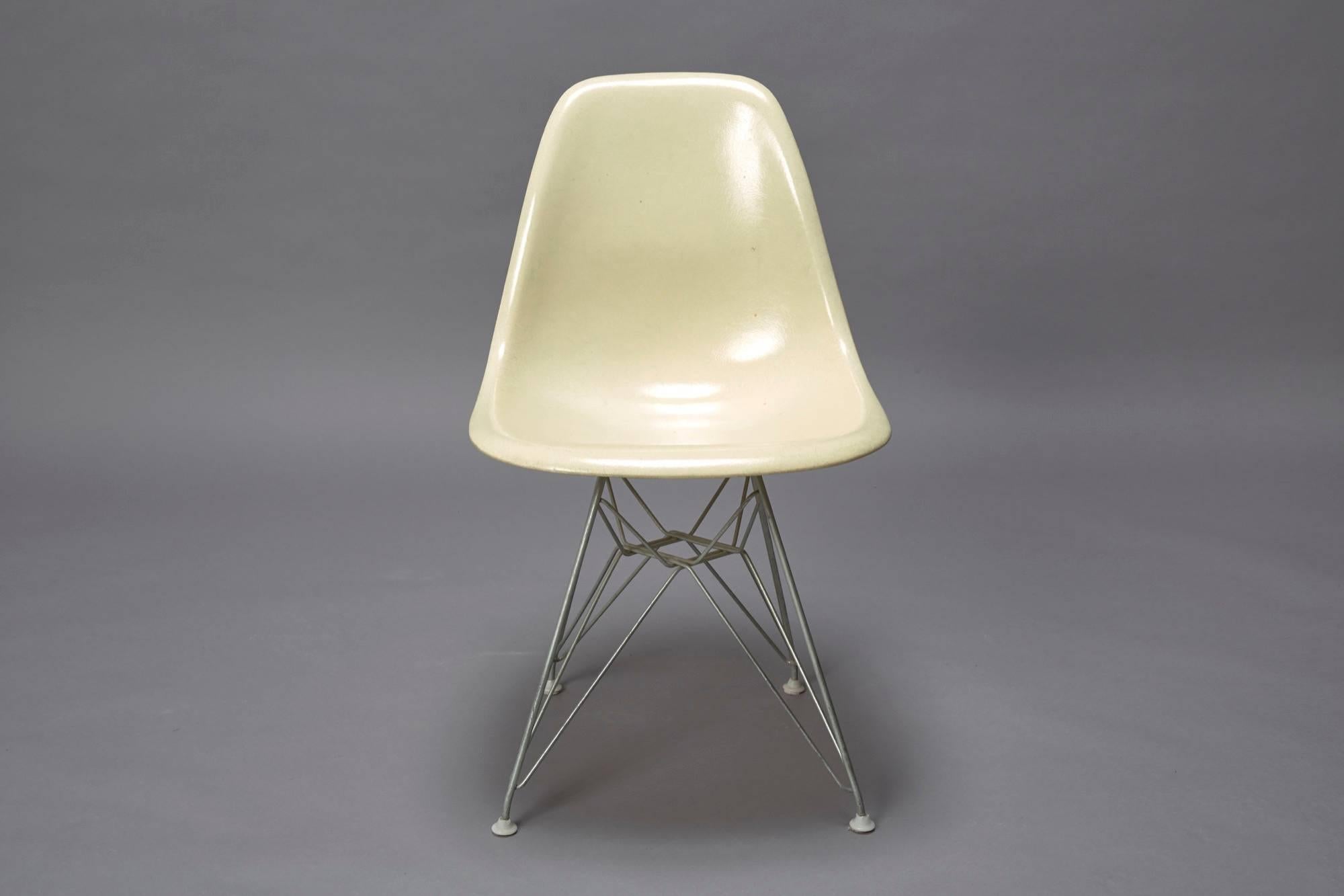 This chair is designed by Charles Eames and produced by Herman Miller in the 1950s. The armless fiberglass bucket/shell chair is on it's original Eiffel base.