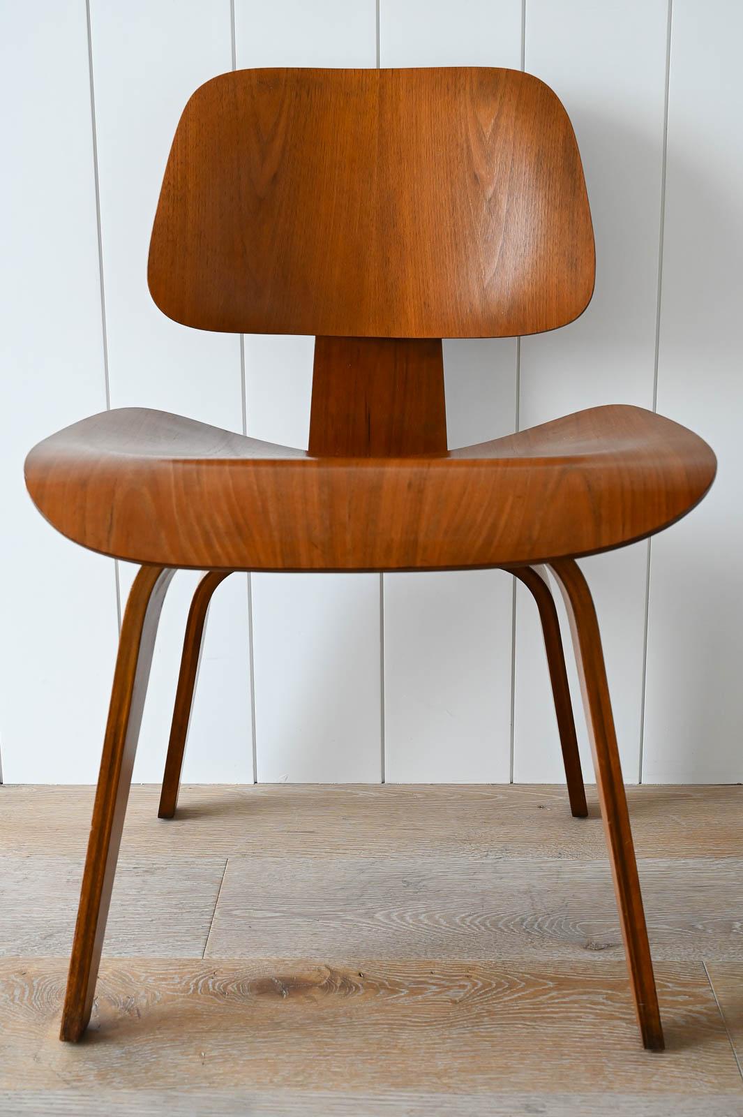 Charles Eames for Herman Miller 1st Generation Early Walnut DCW, ca. 1950.  Very early and well preserved first generation Herman Miller DCW (Dining Chair Wood) in Walnut.  Retains all original aluminum floor glides and original oval shaped shock