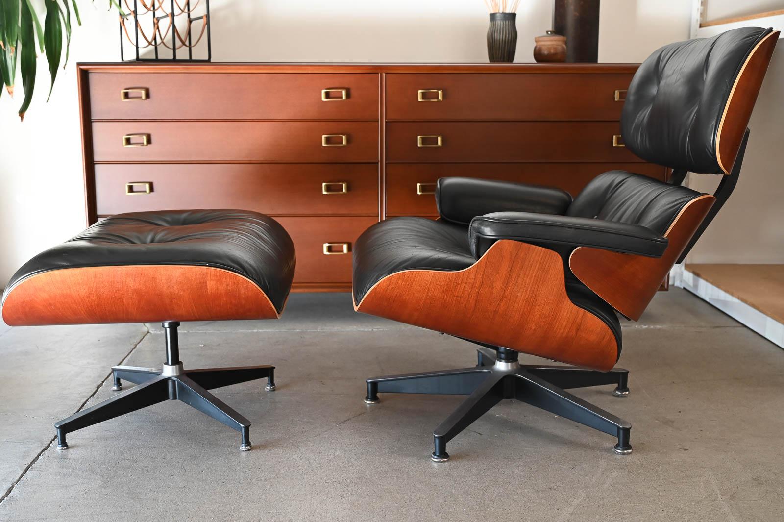 Charles Eames for Herman Miller 670/671 Lounge Chair and Ottoman, 1992.  Beautiful Charles Eames Lounge chair with ottoman in desirable smooth black leather.  Chair has beautiful cherry wood sculpted frame and black leather that has been