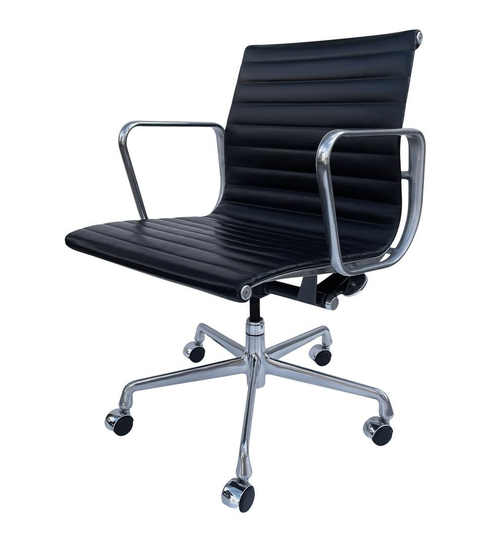 A classic pair of Aluminum Group office chairs designed by Charles Eames for Herman Miller. They feature cast aluminum frames with black leather seats. Fully adjustable task chairs on casters. We have a few sets in stock. Please let us know your