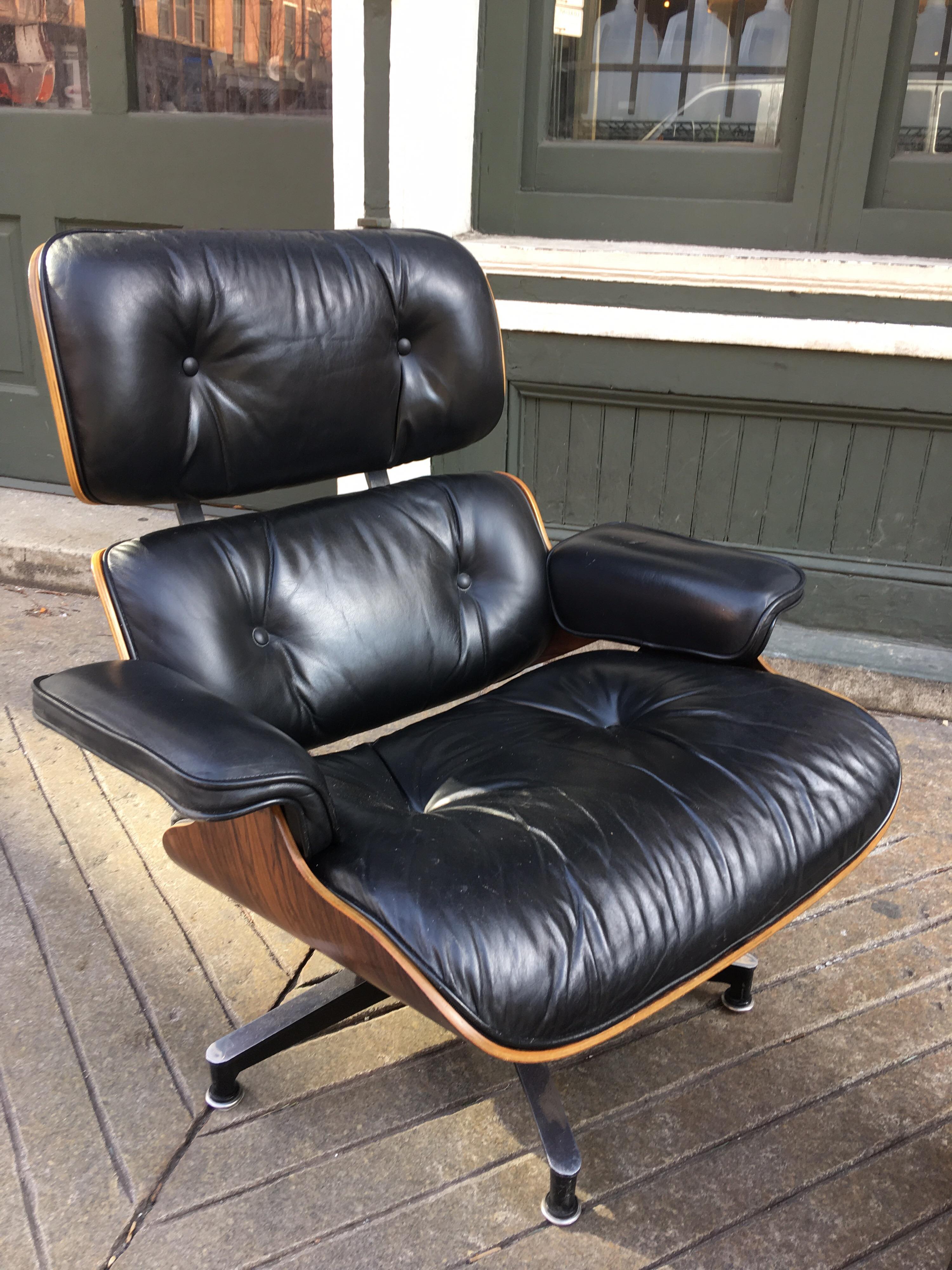 Charles Eames for Herman Miller Rosewood 670/71 lounge chair and ottoman from the 1970s bought from original owner. Chair is perfect except for two minor slits (not piercing leather) on one arm rest. Rosewood is beautifully grained. All feet glides
