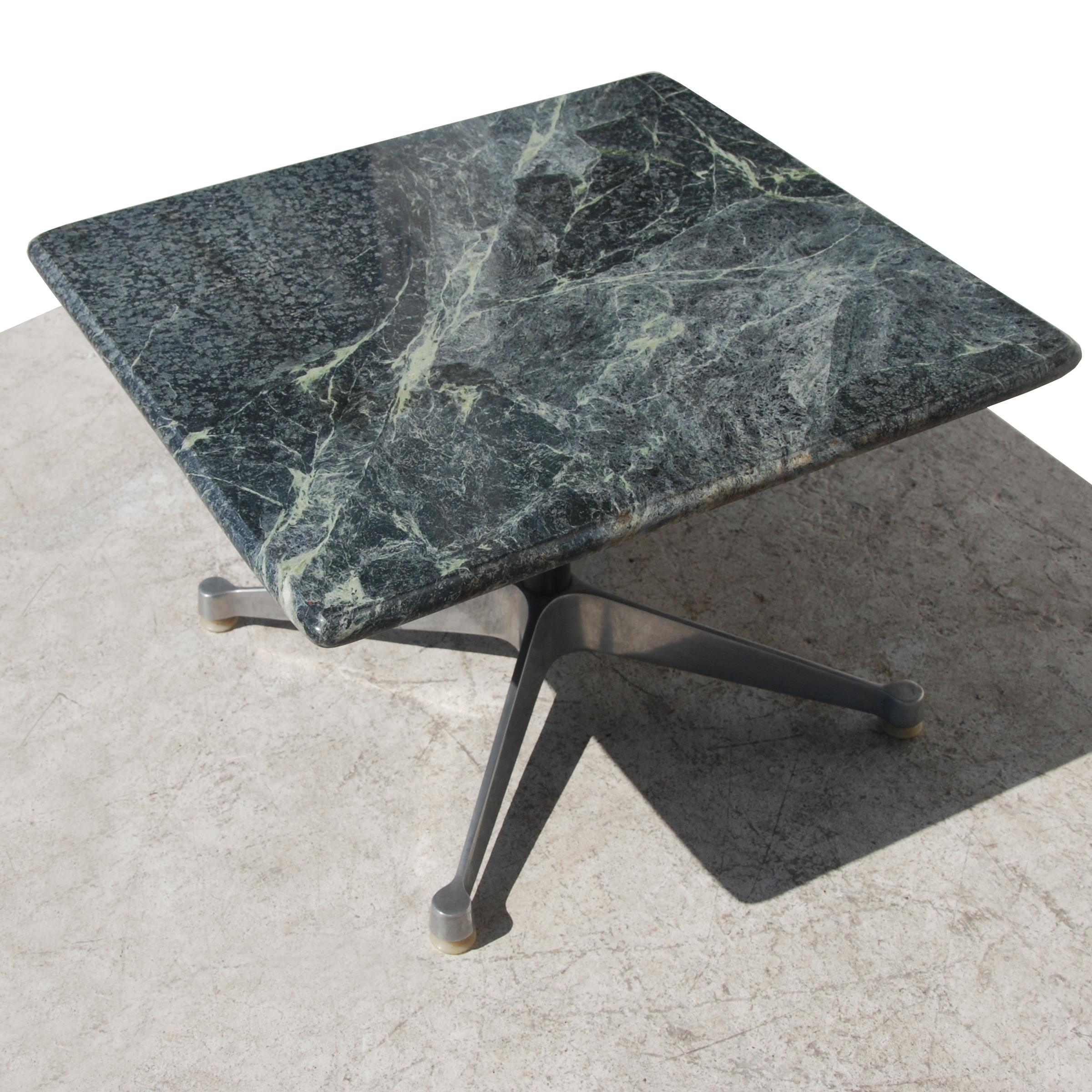 A Mid-Century Modern coffee table designed by Charles and Ray Eames for Herman Miller. An extruded aluminum four star base with a rich green marble top.