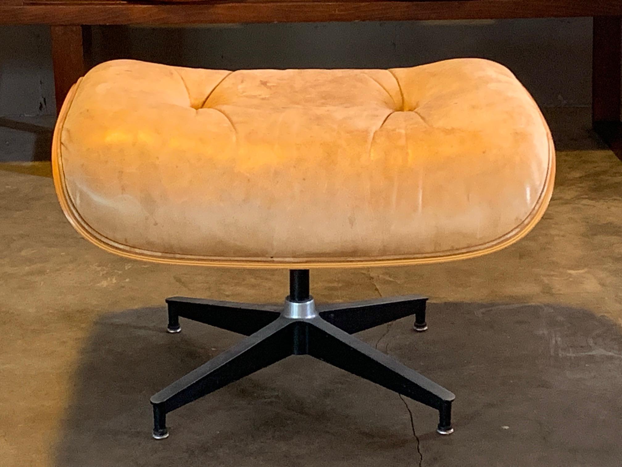 A Classic ottoman designed by Charles Eames for Herman Miller (known as 671). Nice patina well worn. Laminated cherry plywood shell.