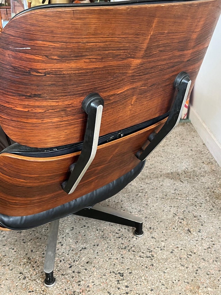 Beautiful Charles Eames, Herman Miller lounger chair and ottoman, 1960's. Classic black leather and rosewood with excellent graining. The chair has a well worn feel with cat scratches especially on the ottoman-see pics. Rosewood has a particularly