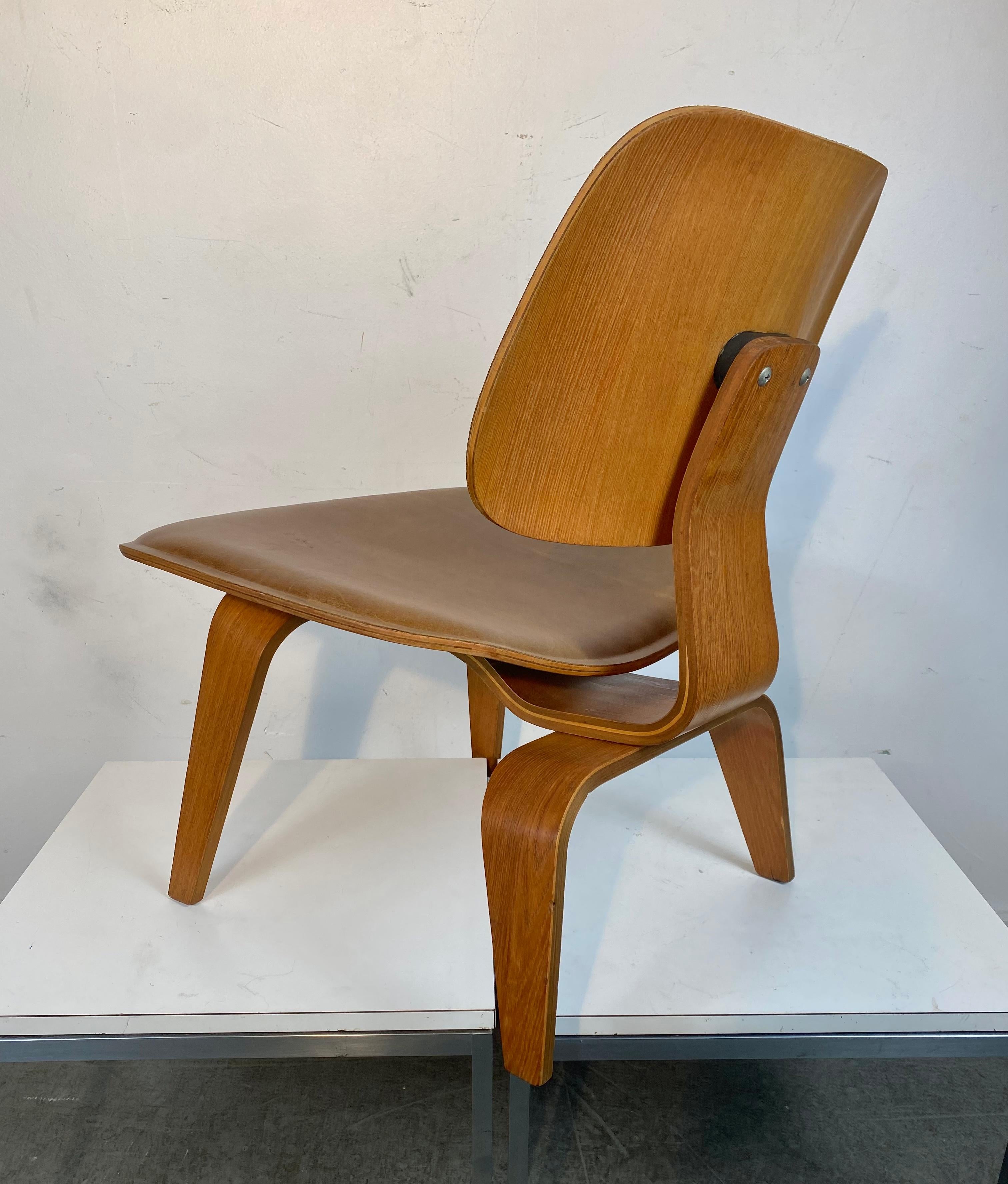 An exceptional original LCW in factory leather for Herman Miller, 

These upholstered examples are very rare as they were only available for sale as a special order for five years between 1948-1953.

This examples in incredible condition with a