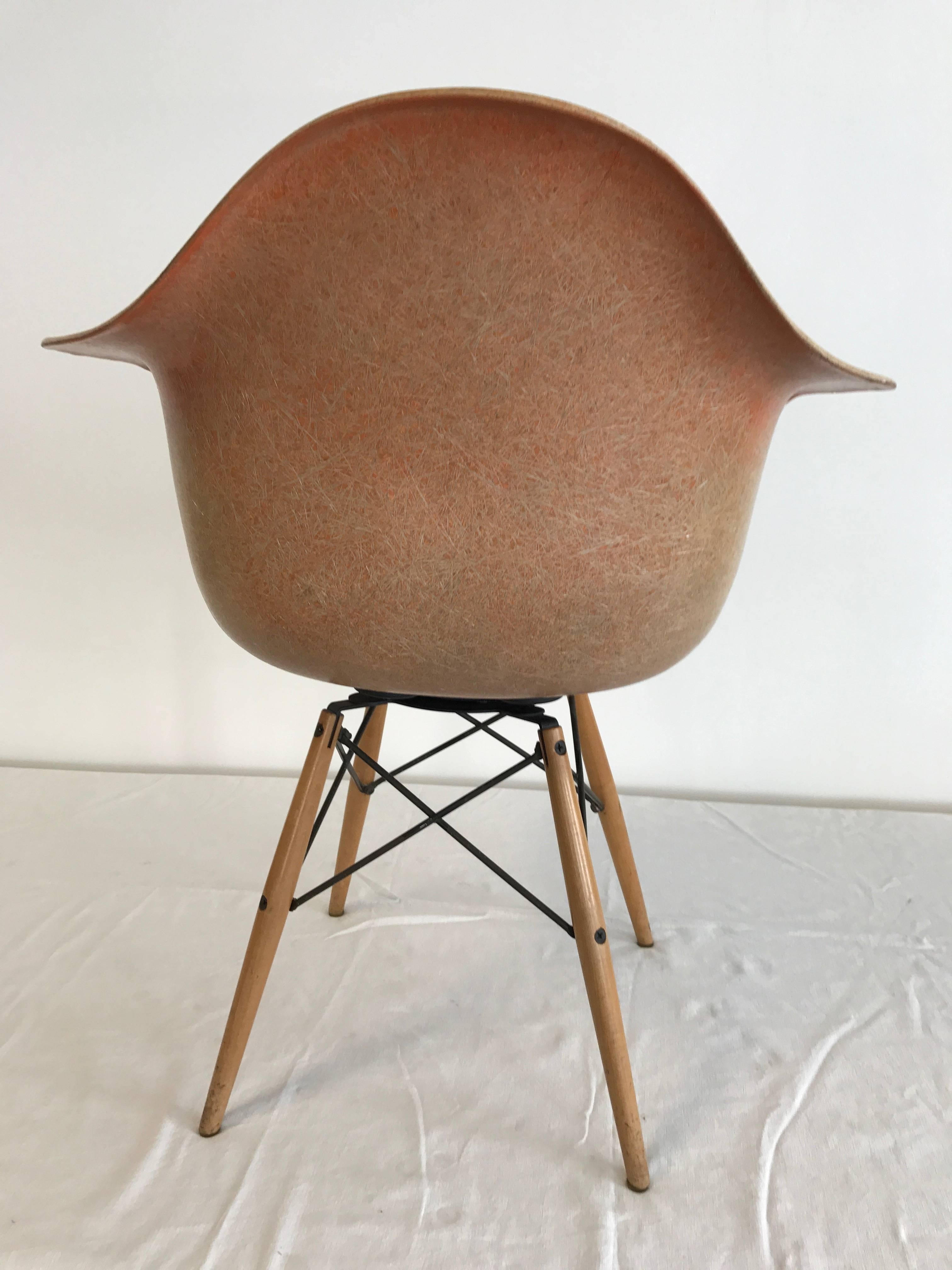Second series after 1950 Zenith Herman Miller / Charles Eames PAW Swivel chair in color salmon (faded) / dowel legs in birch / all original parts / the awesome dowel base reads Seng Chicago on the metal portion/ fibre glass shell in color salmon