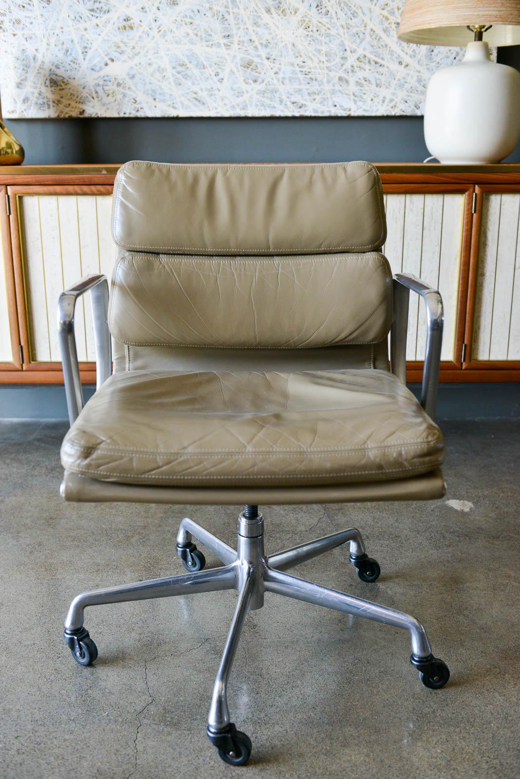 Charles Eames soft pad management chair in tan leather. Original with tags from 2003. Beautiful warm tan leather with just the right amount of break in. Aluminum frame with casters and adjustable tilt. Manual adjustments. Beautiful chair for your