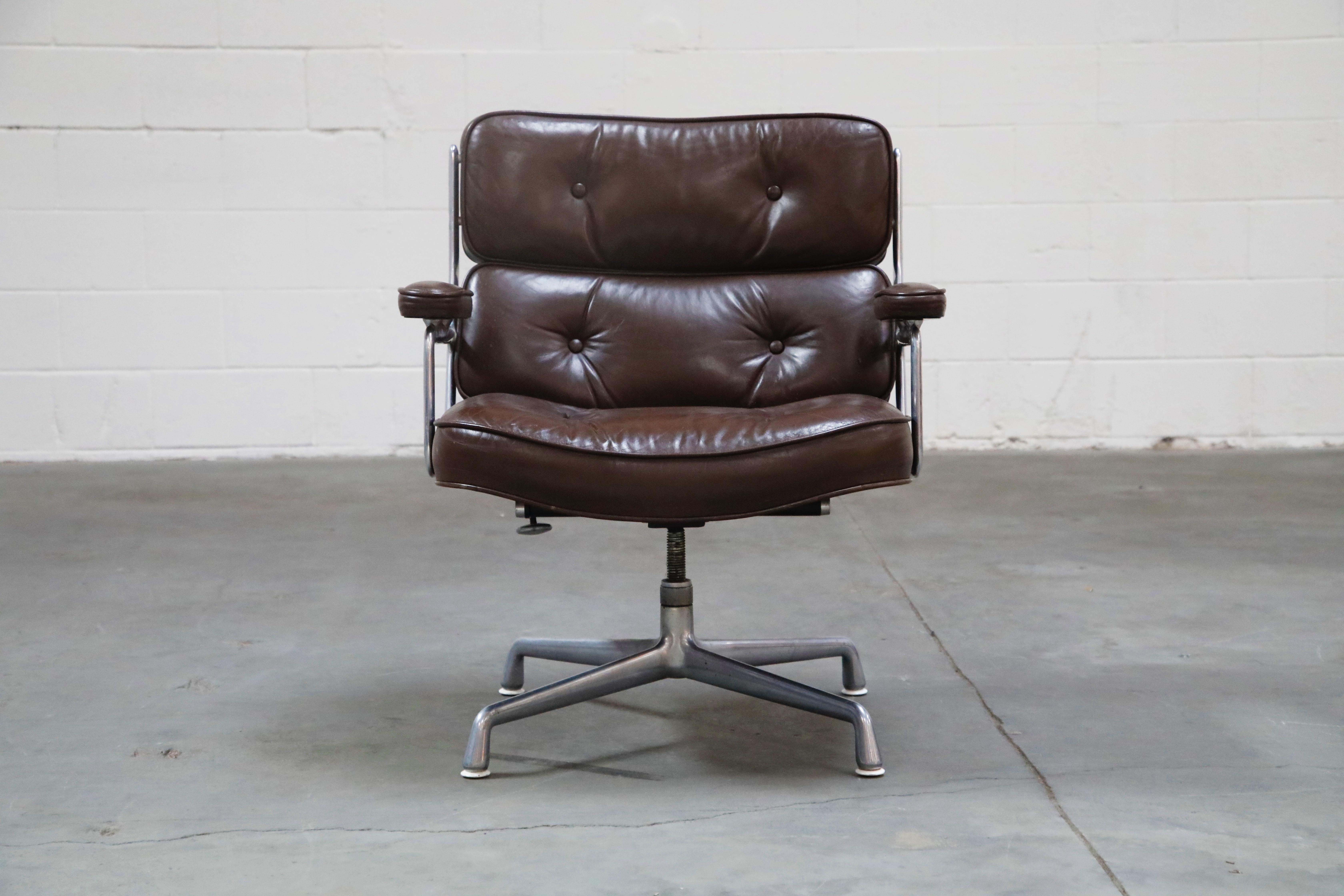 This wonderful pair of Time Life 'Lobby' lounge armchairs were designed by Charles Eames in 1959 and manufactured by Herman Miller, these examples produced in the 1970s. This handsome pair features its original deep chocolate brown colored leather