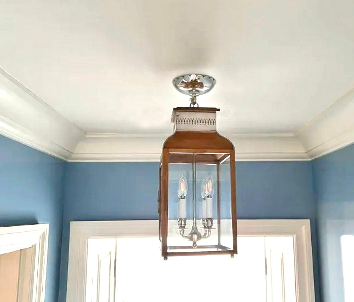Charles Edwards Custom French Lantern Pendant fixture, Mahogany & Nickel, UK. This Charles Edwards Custom French lantern ceiling light fixture is finished with a scalloped polished nickel canopy, a 4-light candelabra, wood frame, glass panes, and