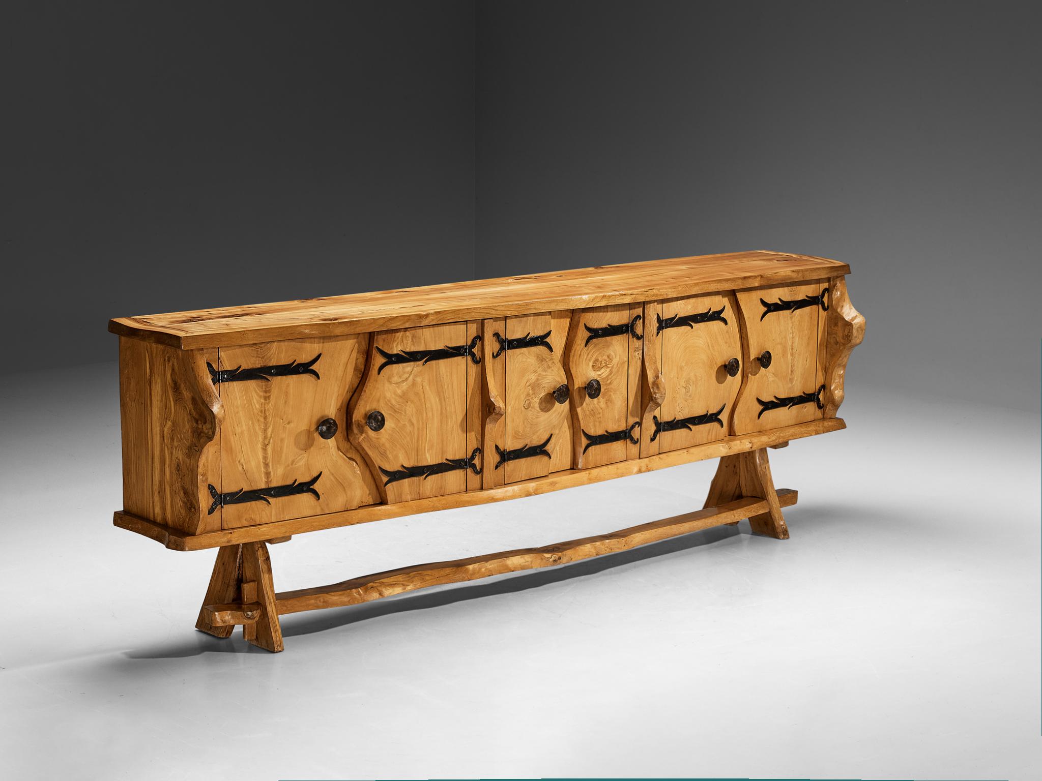 Charles Flandres, sideboard, solid elm, wrought iron, France, 1960s

The French cabinetmaker Charles Flandres has crafted this exquisite credenza, seamlessly combining rustic charm with organic elegance. The design features graceful, free-flowing
