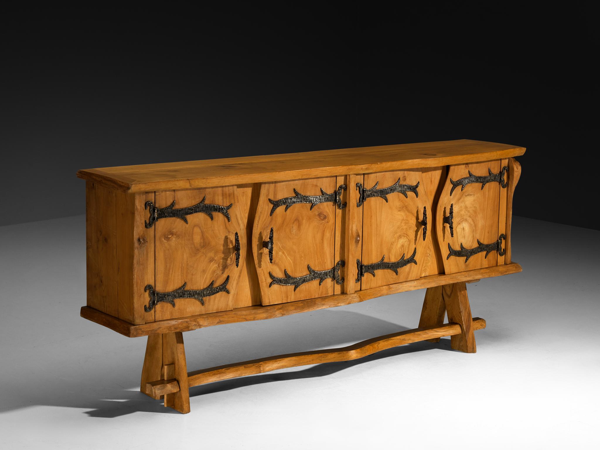 Charles Flandres, sideboard, solid elm, pine, wrought iron, France, 1960s

Crafted by French cabinetmaker Charles Flandres, this exquisite elmwood sideboard beautifully blends rustic charm with organic elegance. Its free-flowing edges highlight the