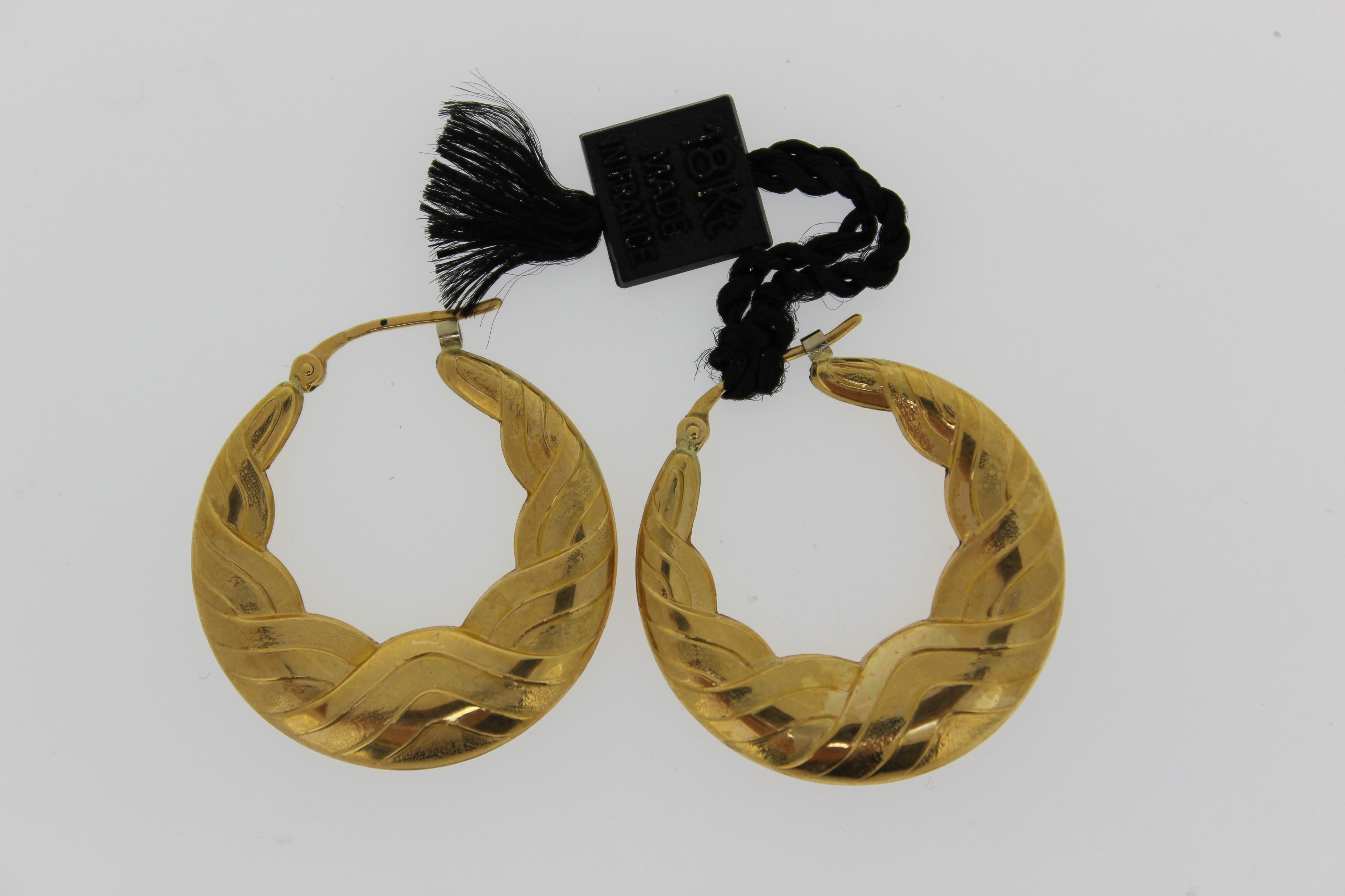 This is one of many Charles Garnier from Paris,  18 karat yellow gold hollow hoop earrings.
This collection is from a close out store with its left over stock still in the safe.
Circa 1980's
This designs are extremely detailed with light weight easy