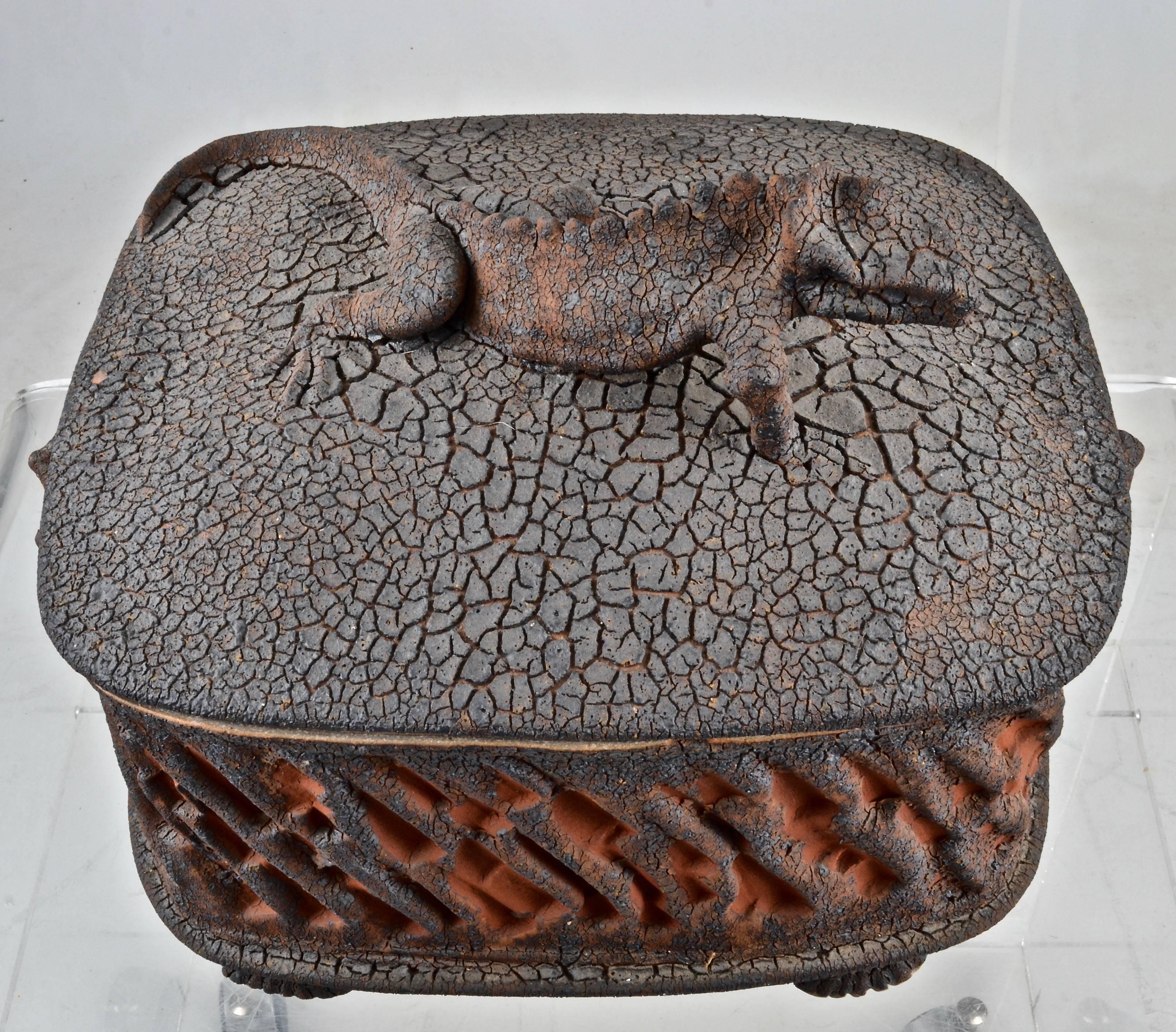 This is an outstanding art pottery work by Charles Gluskoter featuring a lifesize dessert lizard atop a heavily textured lid. Raised faux bois design on sides. The inside of the box/tureen is glazed black. Impressive size at 16 inches wide by 12