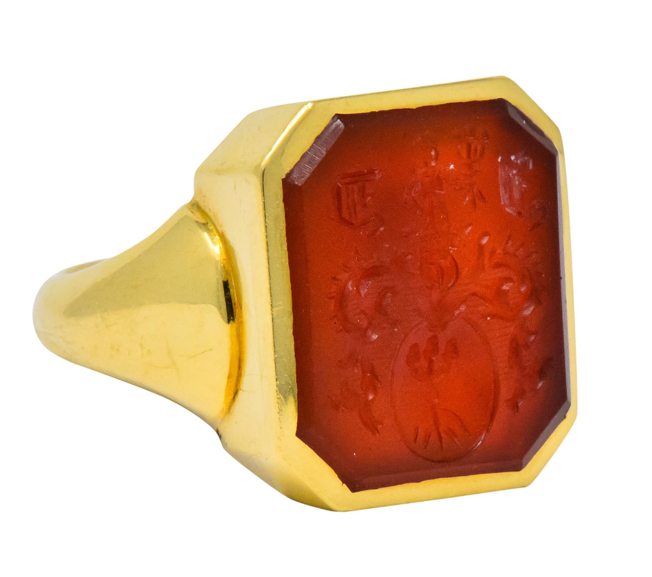 Centering a cut-corner intaglio carved carnelian, measuring approximately 17.0 x 15.0 mm, bright brownish orange

Deeply and highly detailed carving, depicting acorns and a man in native dress with old English lettering

Signed CG& S for Charles