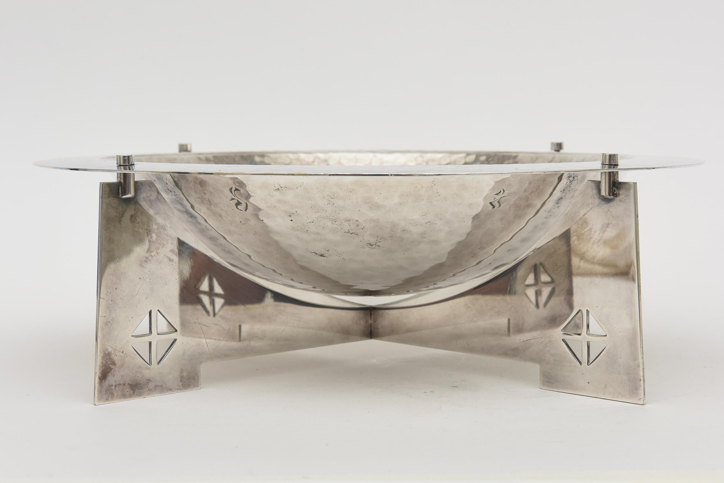 This vintage hand hammered silver-plated brass bowl by the architectural team of Robert Siegel and Charles Gwathmey for Swid Powell is one of the most iconic designs made and also one of the most scarcely found. It is called the Courtney Centerpiece