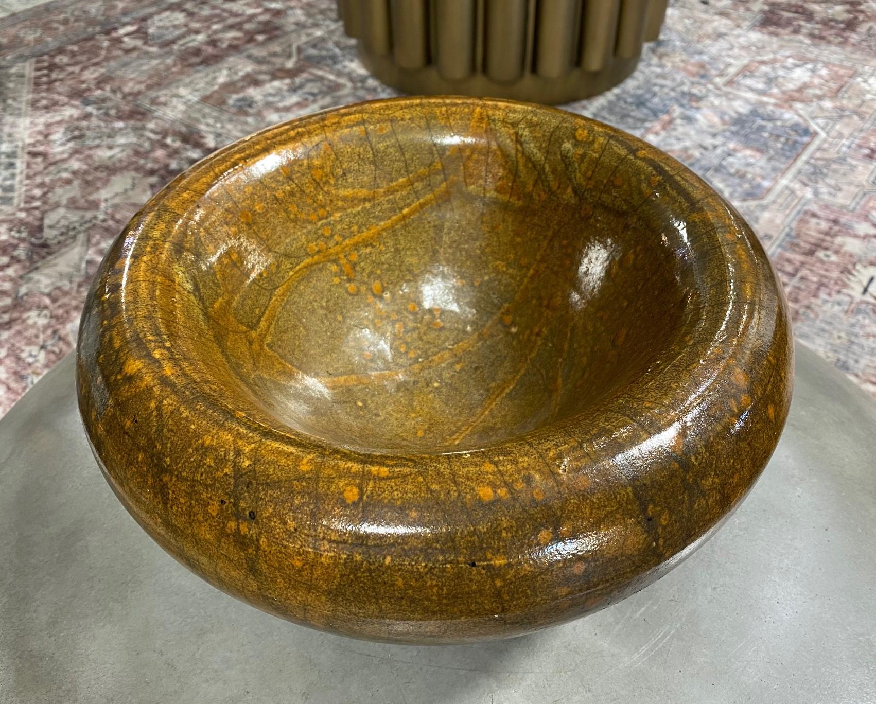 A wonderful and gorgeously designed and glazed bowl by Hawain potter/artist Ed K Higa (initially we thought this bowl was by Charles Higa, also a Hawaiin artist but now believe it is Ed Higa's work). 

The raku-fired bowl has a Wabi-Sabi feel and