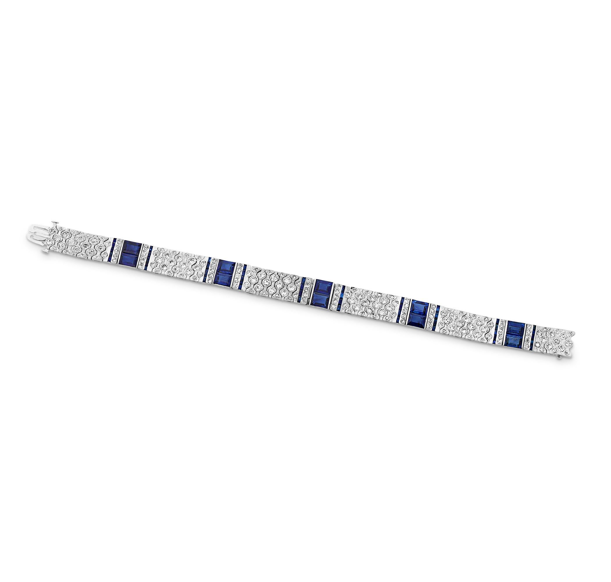 This fabulous Art Deco bracelet epitomizes the timeless glamour of the period. Featuring 6.65 carats of transitional cut diamonds and 7.75 carats of French cut sapphires, the bracelet's intricate geometric design shines with a unique Art Deco