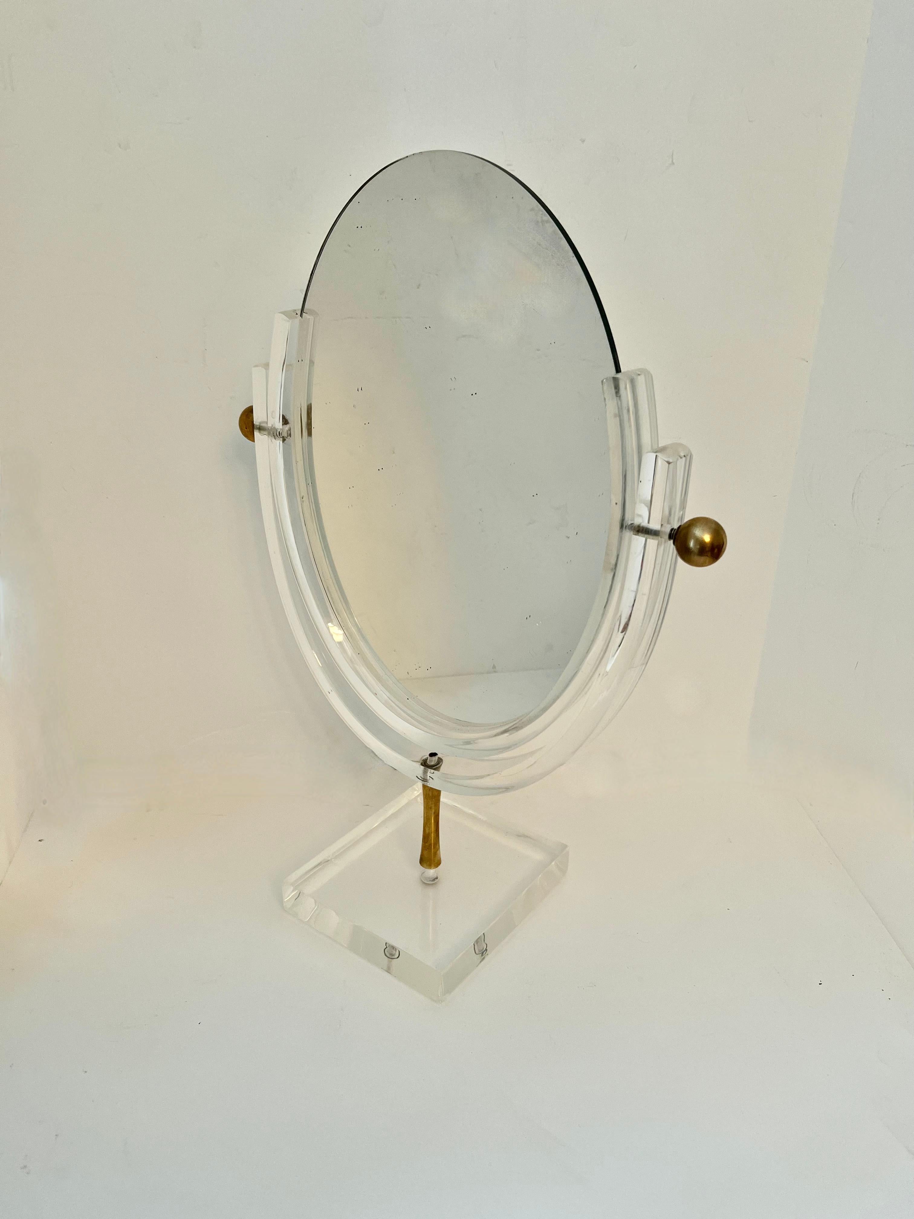 A wonderful acrylic frame mirror with brass finials.  The mirror is double sided so can 'float' in the middle of a room.  A lovely piece with some patina, but we have polished out most of the imperfections.  

A great mid century piece by the man