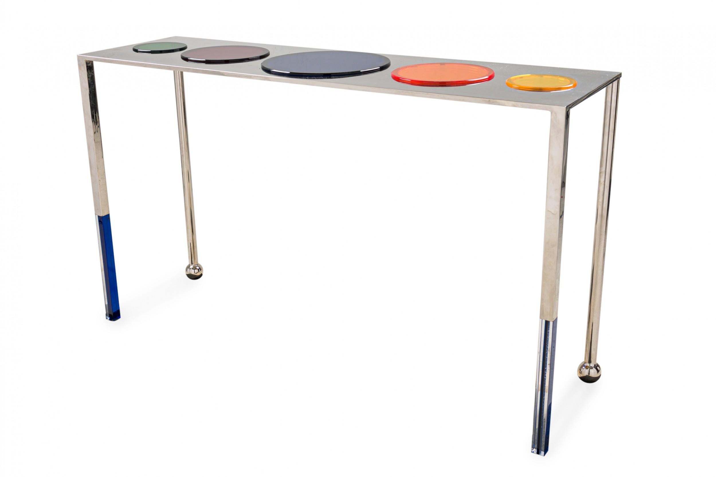 American Contemporary console table with a polished nickel frame and tabletop featuring multi-colored inset lucite disks, resting on four square nickel legs, the front two ending in ball feet. (CHARLES HOLLIS JONES)

Condition: Good; Wear consistent
