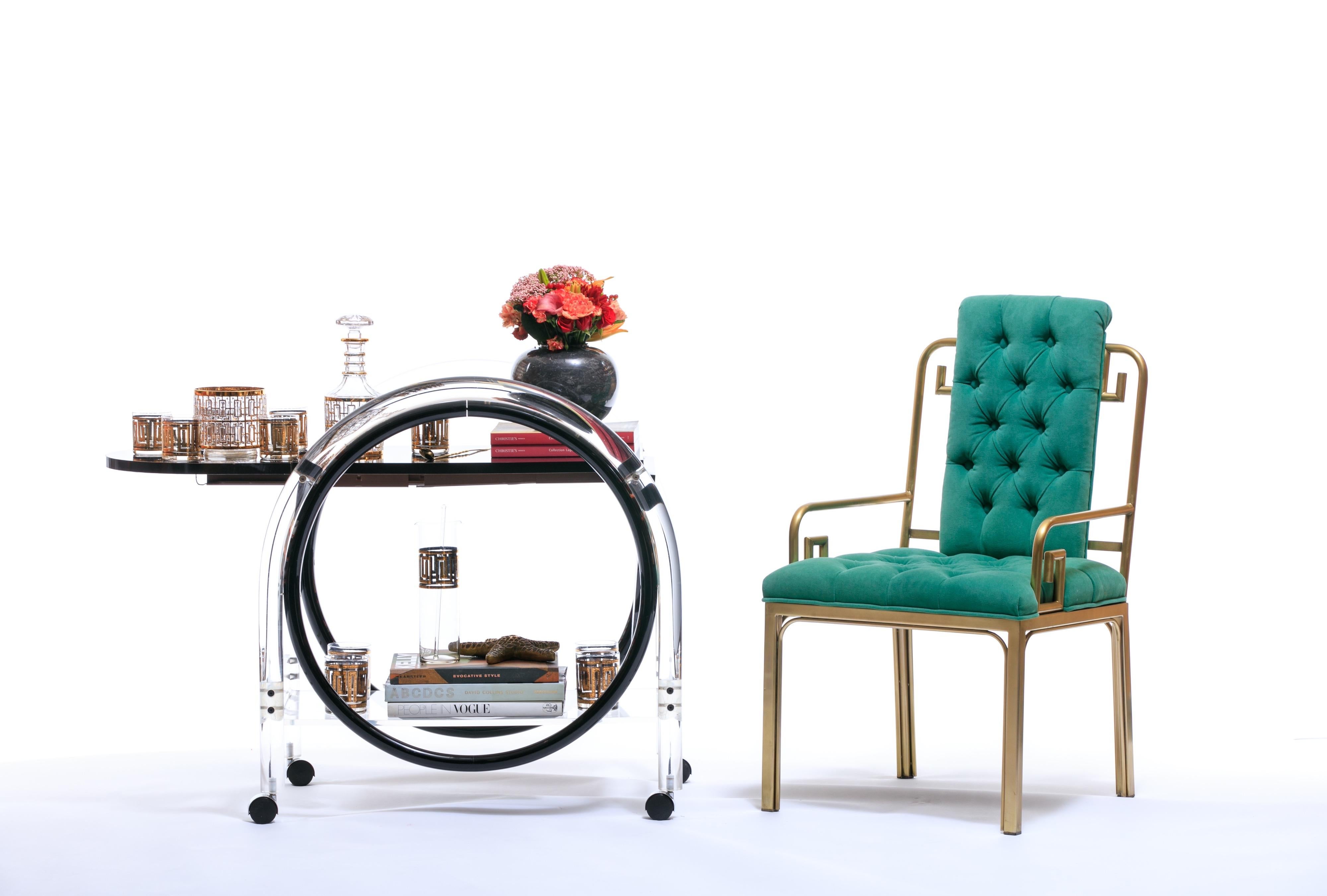 We've seen a lot of beautiful bar carts in our business but this one is like a talent scout's dream come true. The shape, the versatility, the black Formica juxtaposed against that thick circular band of Lucite keeping it all together. Strong 1970s,