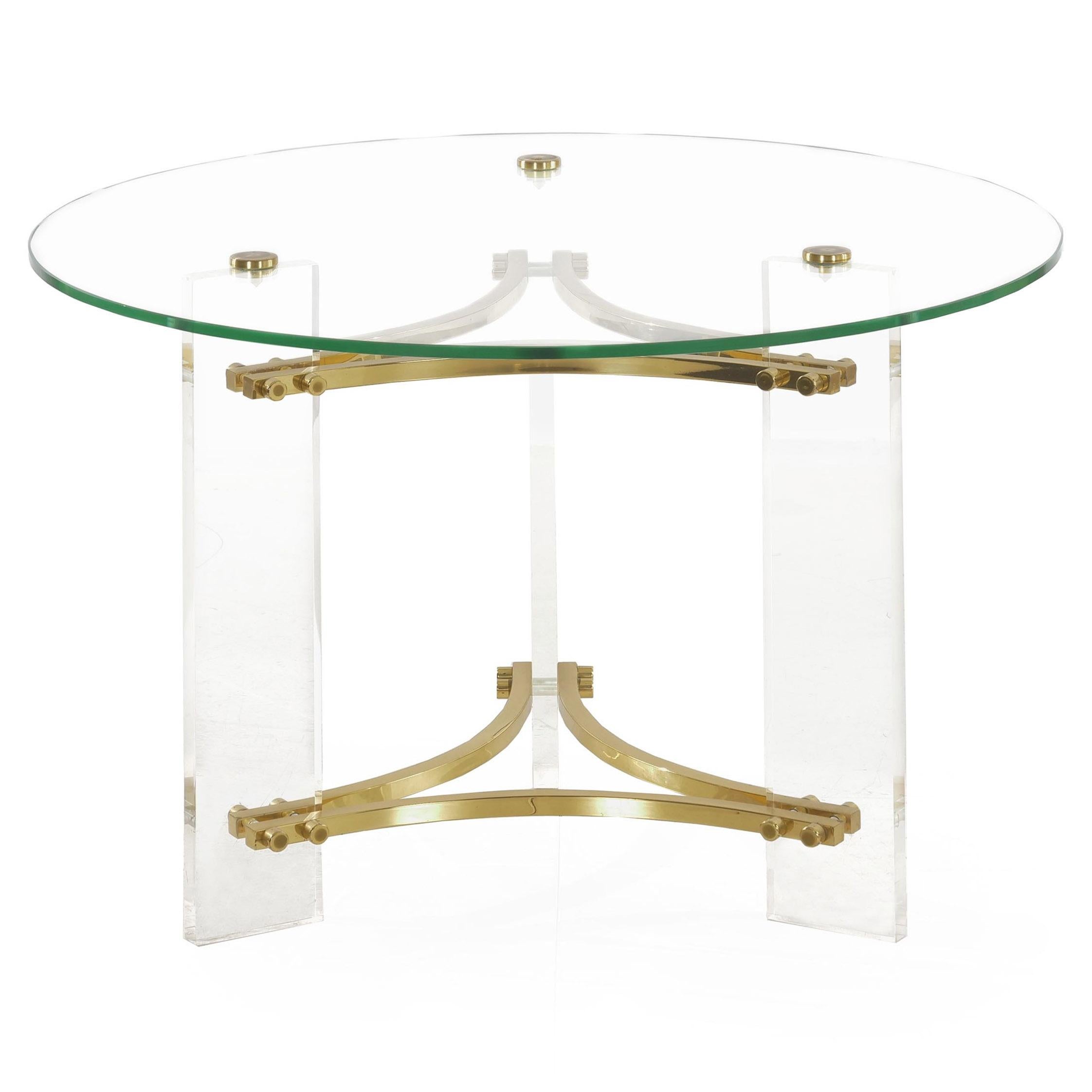 A sleek and attractive accent table designed by Charles Hollis Jones, the austere lines and translucent form allow the table to nearly disappear and leave the brass elements floating in the air. The top is a thick piece of glass affixed with turned