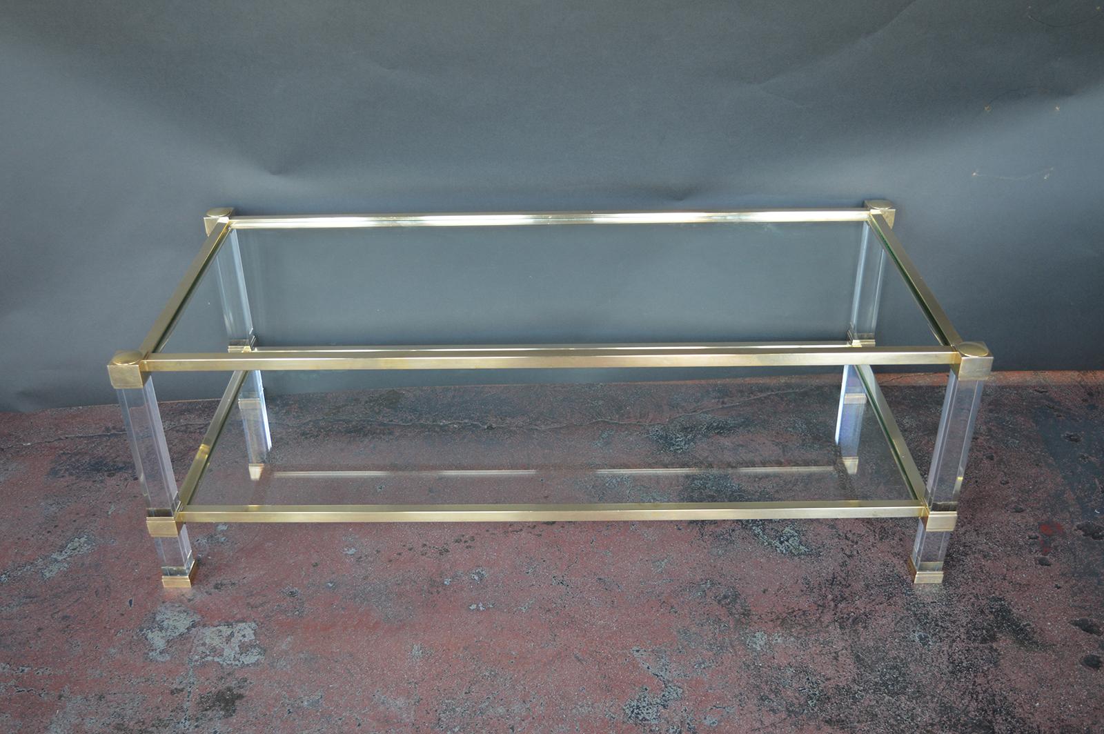 Brass and Lucite coffee table with two tiers, both glass.