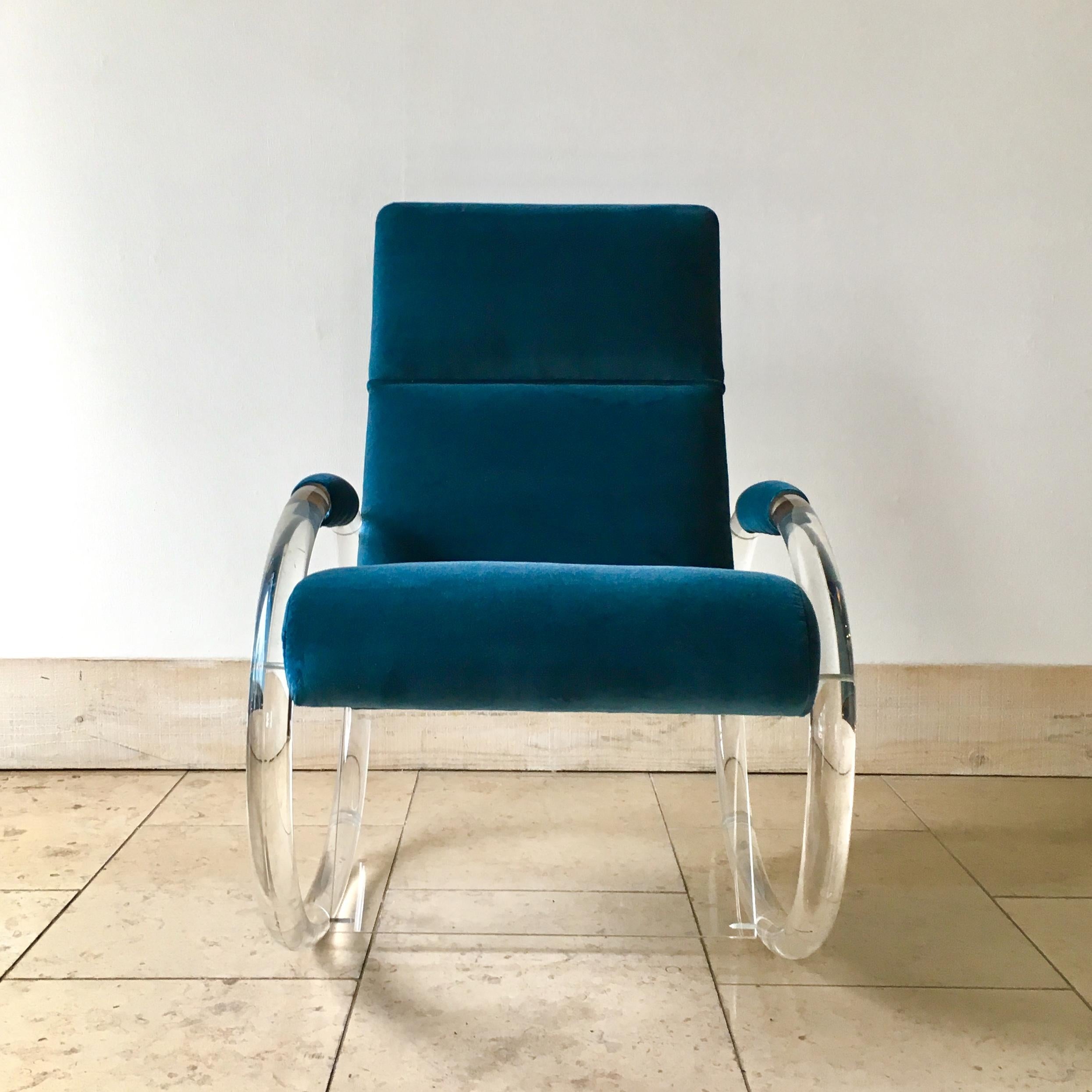 A Charles Hollis Jones designed lucite framed rocking chair 1970s.

Reupholstered by our team in a peacock blue velvet .