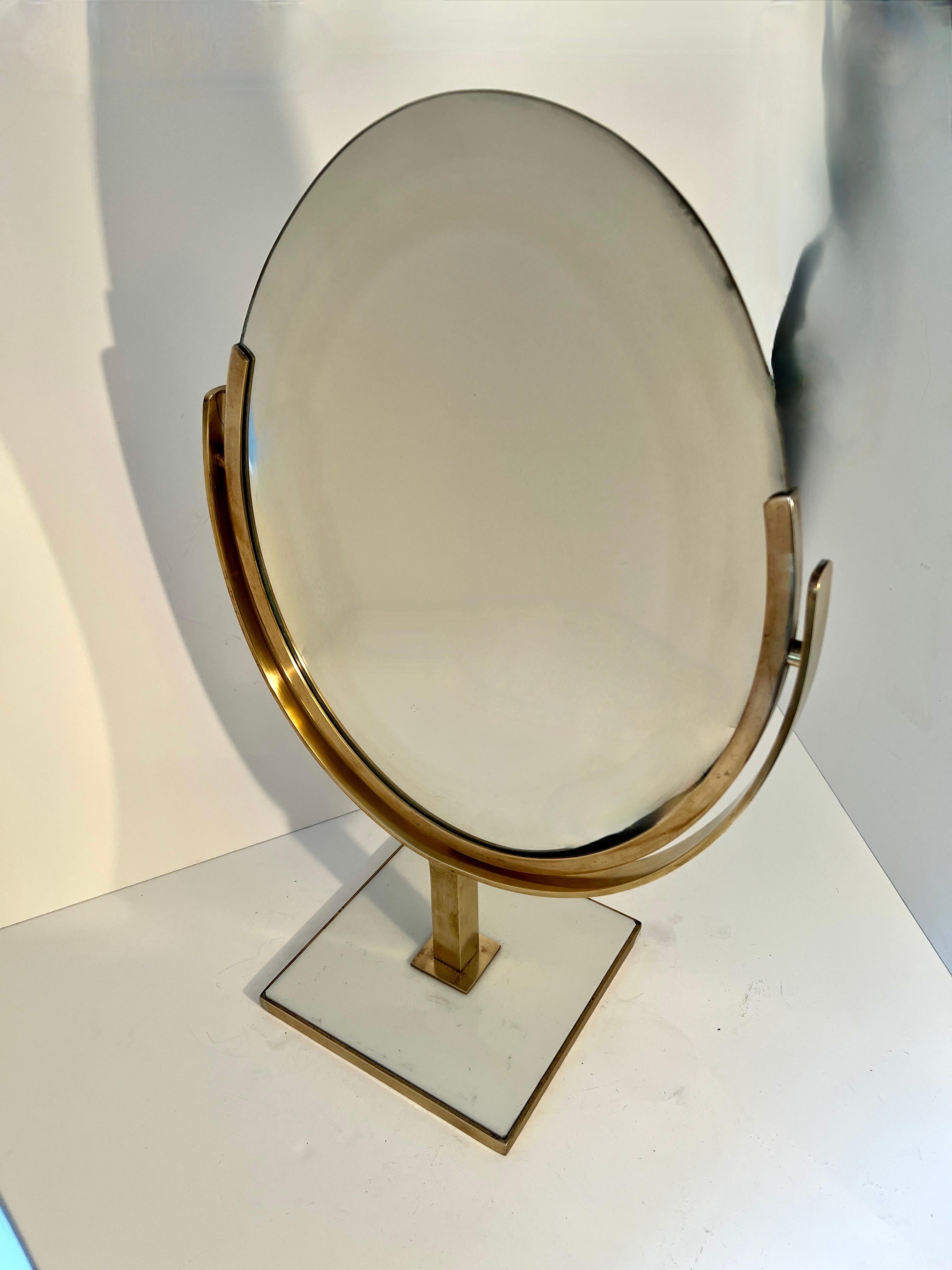 Charles Hollis Jones Solid Brass tilting double sided table mirror on brass stand.

The iconic Designer Charles Hollis Jones, who worked mostly in acrylic is also known for his wonderful table mirrors.  The Mirror is double sided with normal