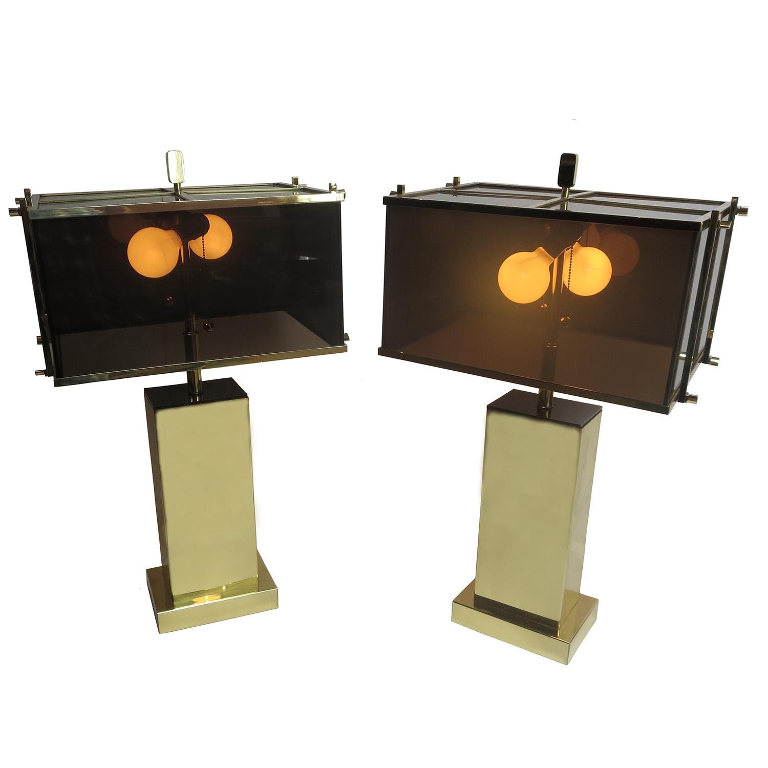 These stylish “Edison” table lamps were designed by Charles Hollis Jones in 1971. They were offered in chrome with clear acrylic shades, or in brass with the smoked acrylic shades, as shown here. The lamps are in excellent original condition, and