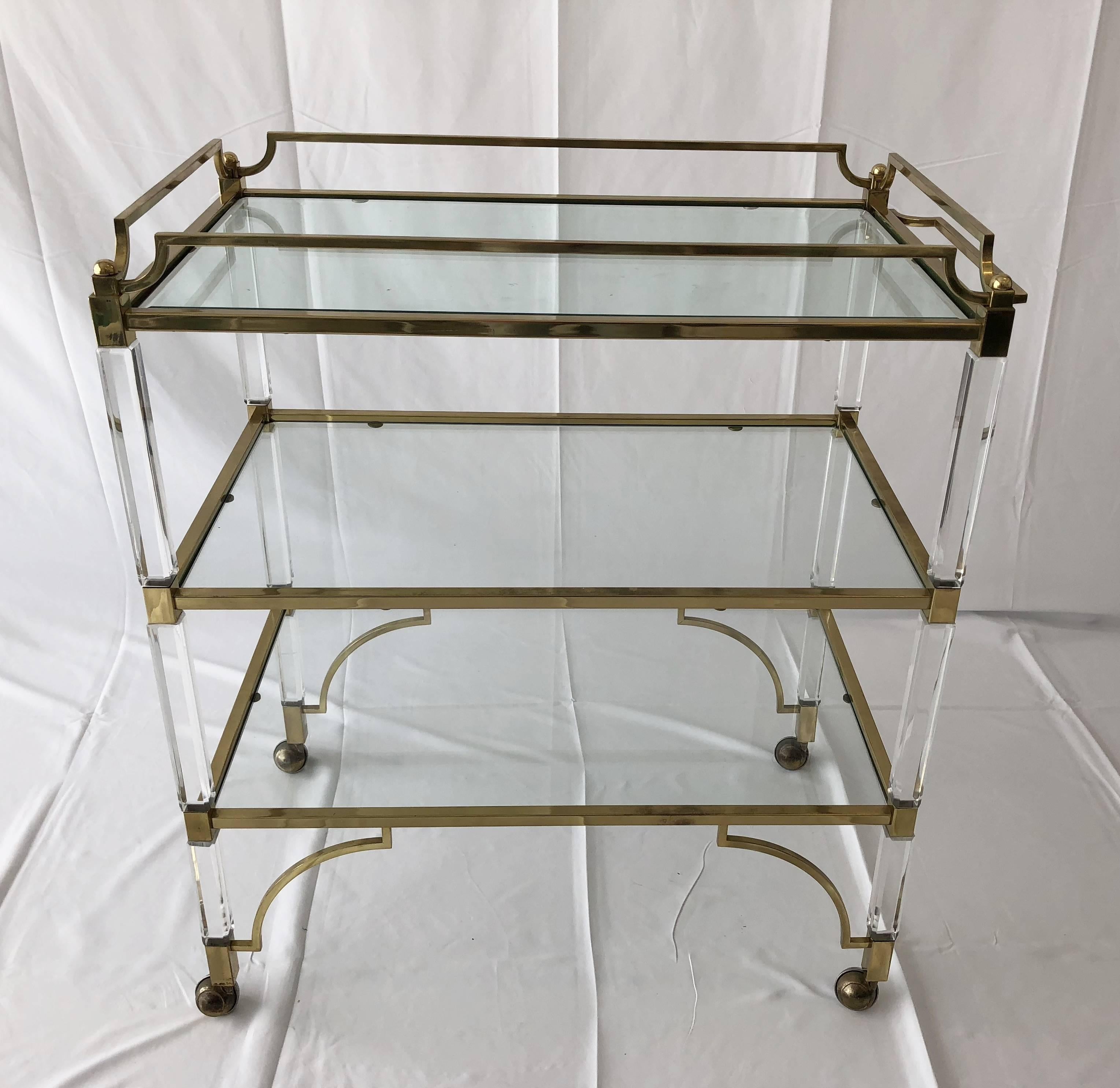 Beautiful and rare Lucite and brass serving/bar cart designed by Charles Hollis Jones and manufactured by Swedlow in the early 1960s, this piece is part of the 