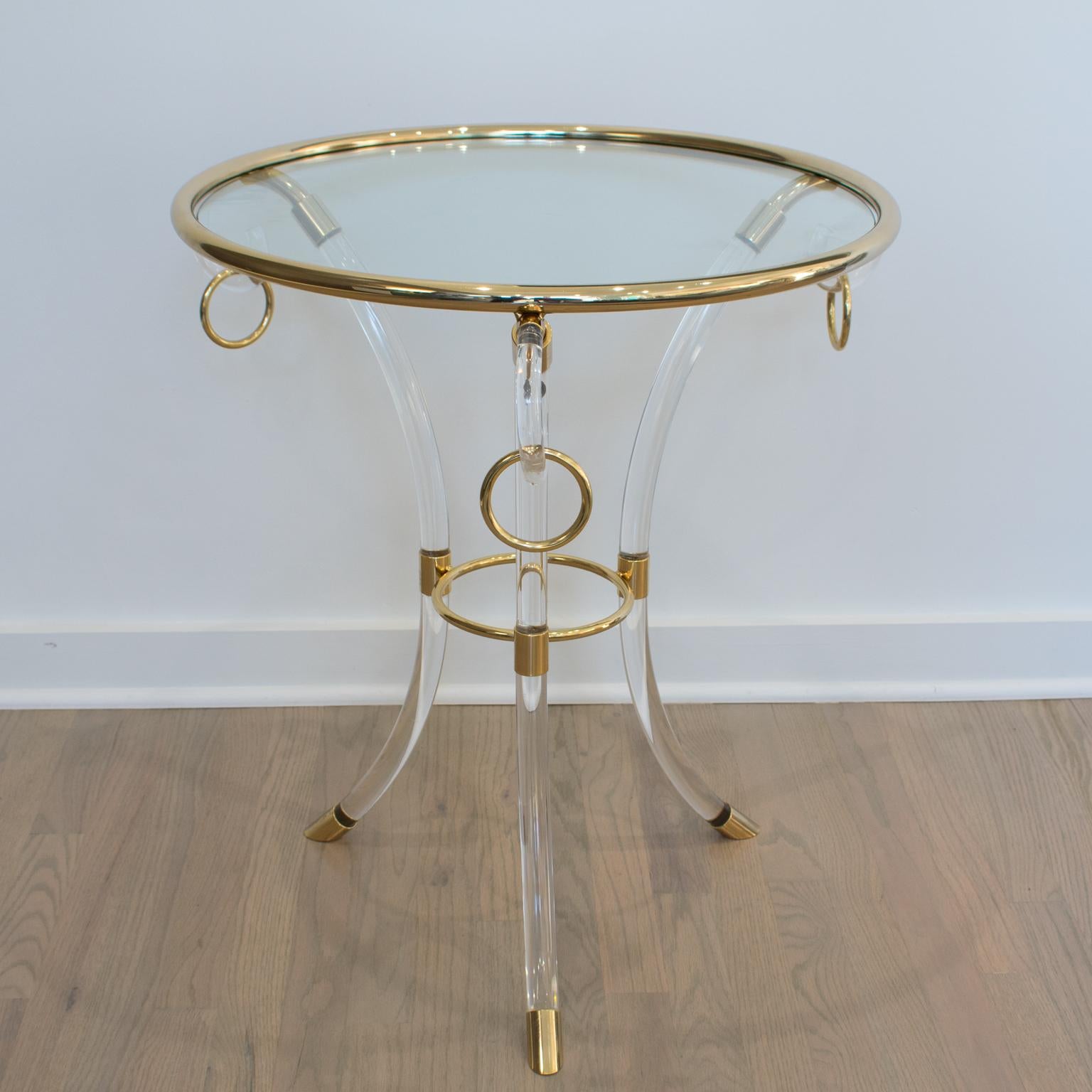 Charles Hollis Jones designed this exceptional Mid-Century modernist Lucite and brass coffee or side table. The round Directoire-style pedestal table is made with clear Lucite and gilded brass resting on three arched feet with an upper part in the