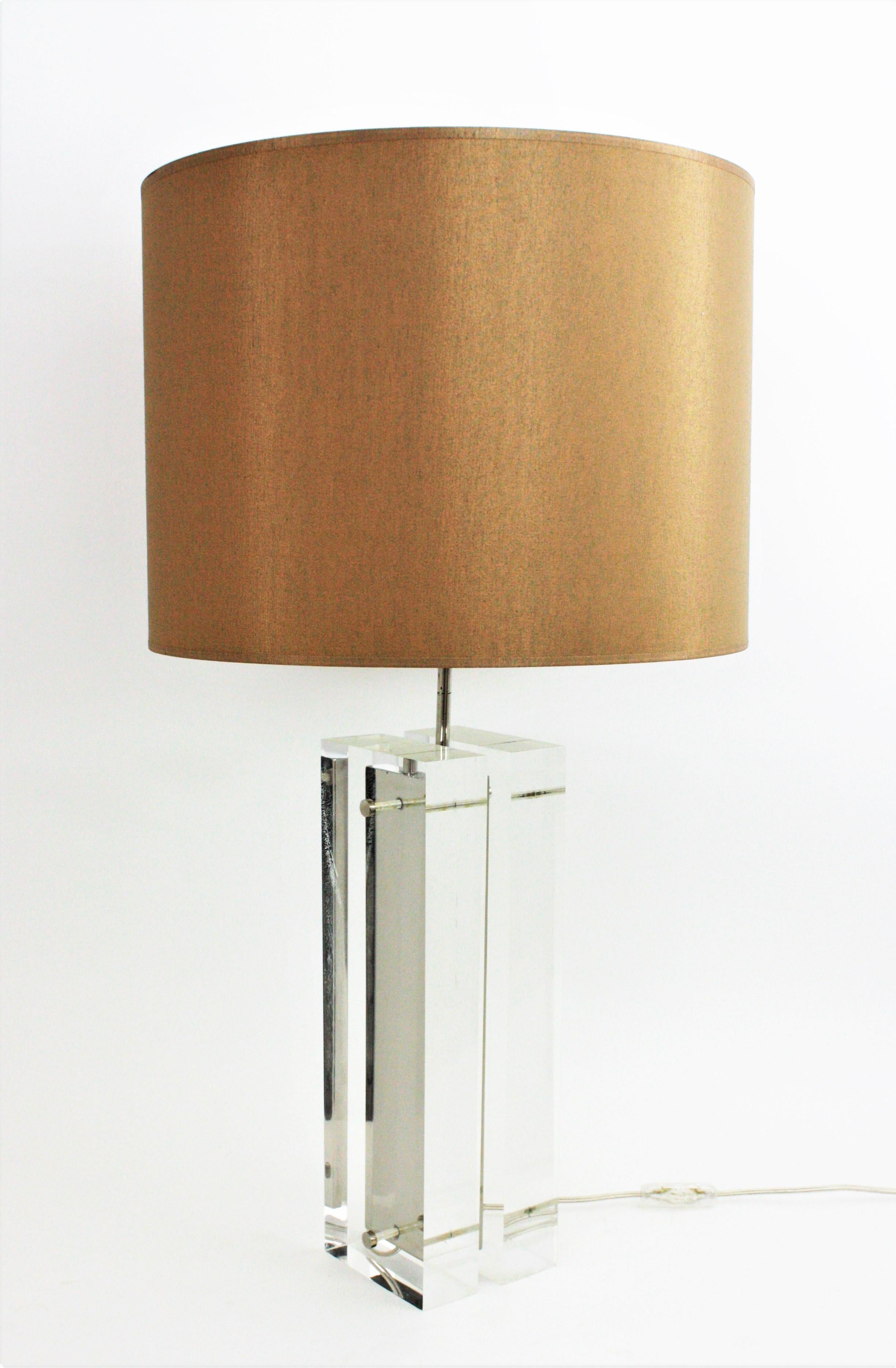 A large Lucite and chrome table lamp by Charles Hollis Jones. United States, 1970s.
This architectural table lamp features two thick Lucite blocks joined between them with a chromed steel panel.
The shade is not included.
Newly wired with an E27