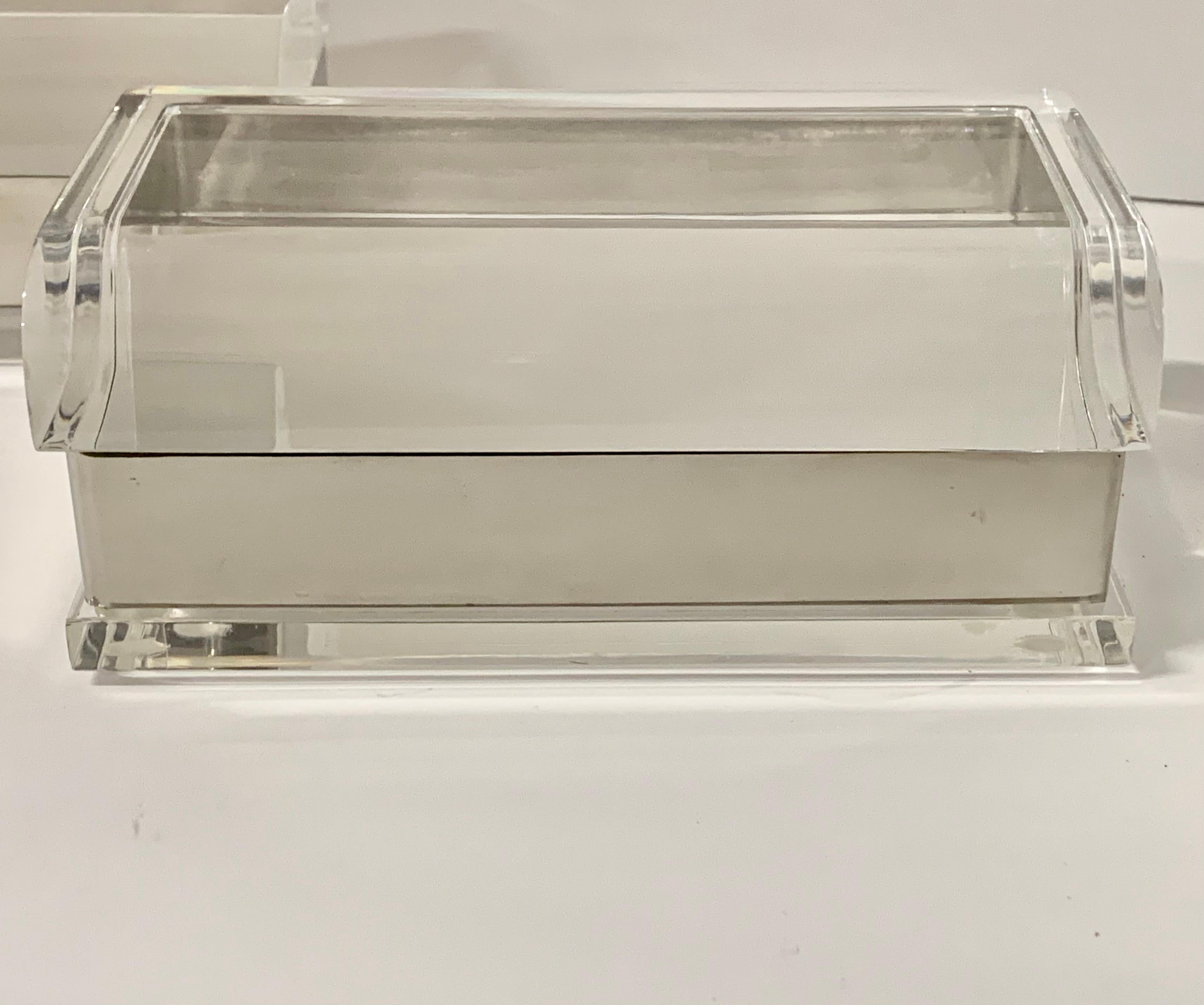 A pair of Charles Hollis Jones covered boxes in Lucite with nickel trim. These are vintage boxes purchased directly from Mr. Jones. They measure approx 7 by 4.25 inches in dimension and 3 inches in height. In good age appropriate vintage condition.